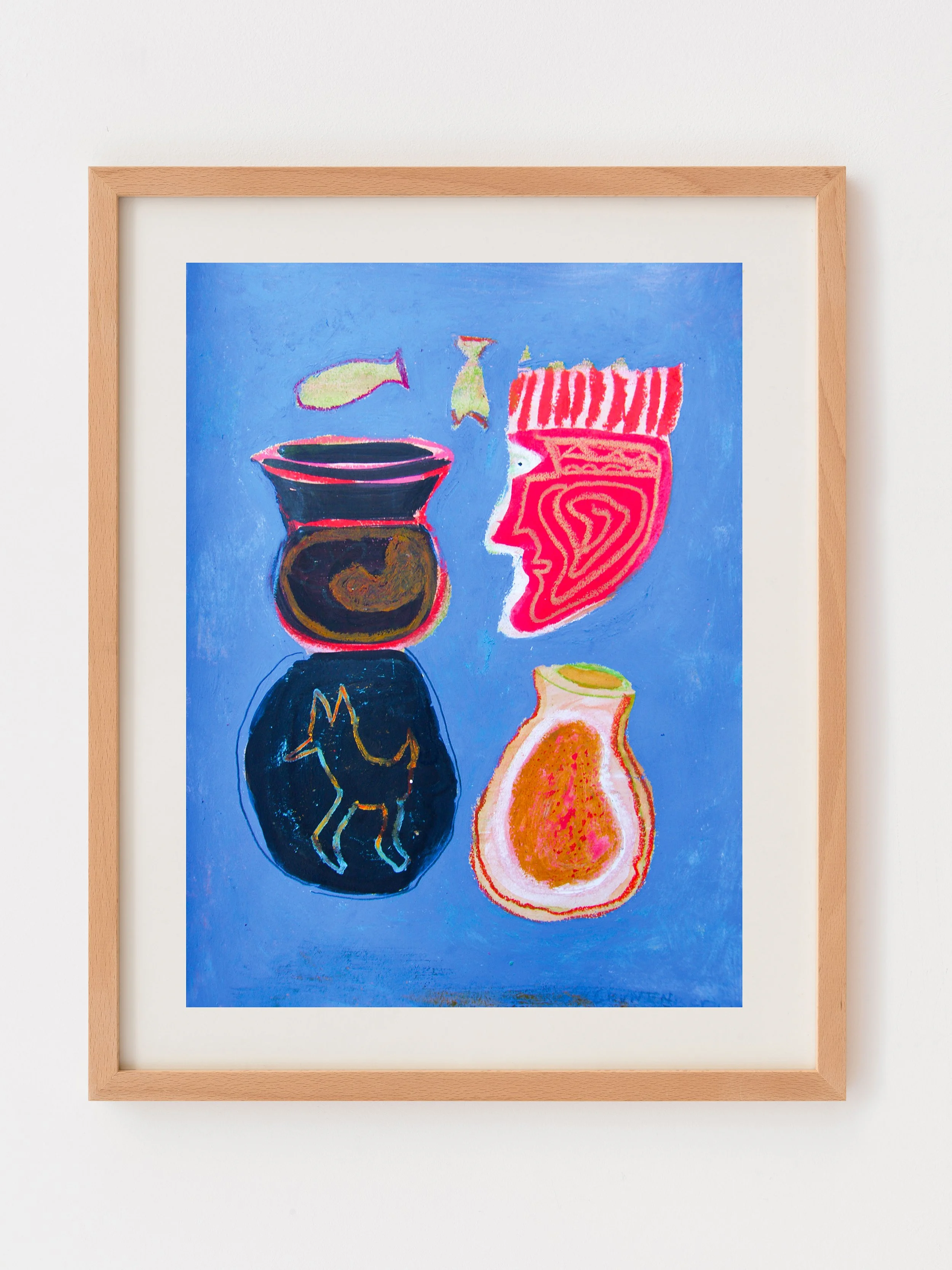Colorful abstract artwork depicting a fish bowl with two fish, a stylized human face, a pear, and a peach on a blue background, framed with a light wooden frame.