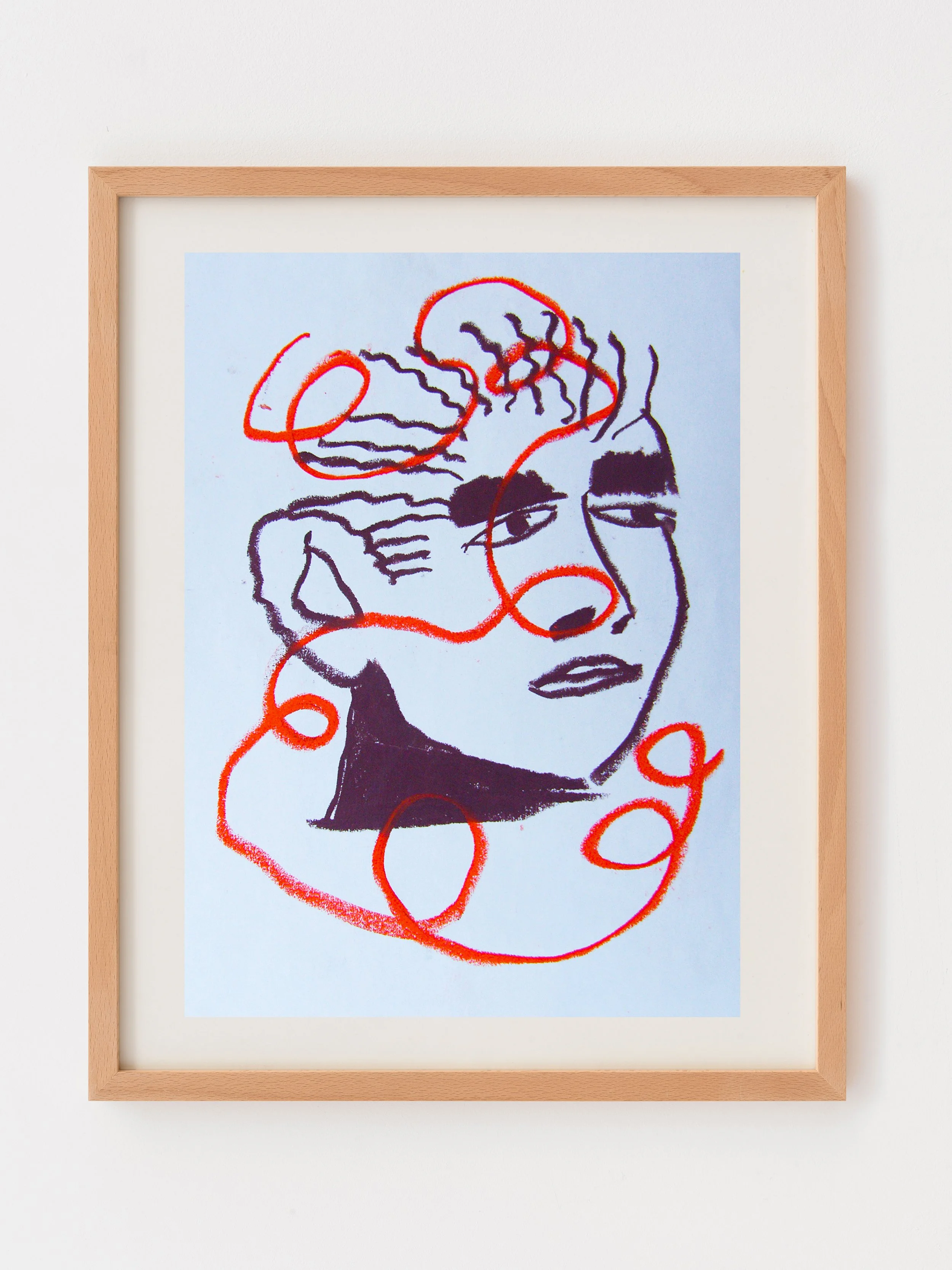Framed abstract artwork of a line drawing of a person's face with swirling red lines over it, on a white wall.