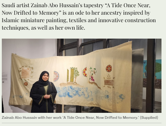 Saudi artist Zainab Abo Hussain standing next to her tapestry 'A Tide Once Near, Now Drifted to Memory,' displayed on the wall, featuring Islamic miniature painting motifs, textiles, and innovative construction techniques.
