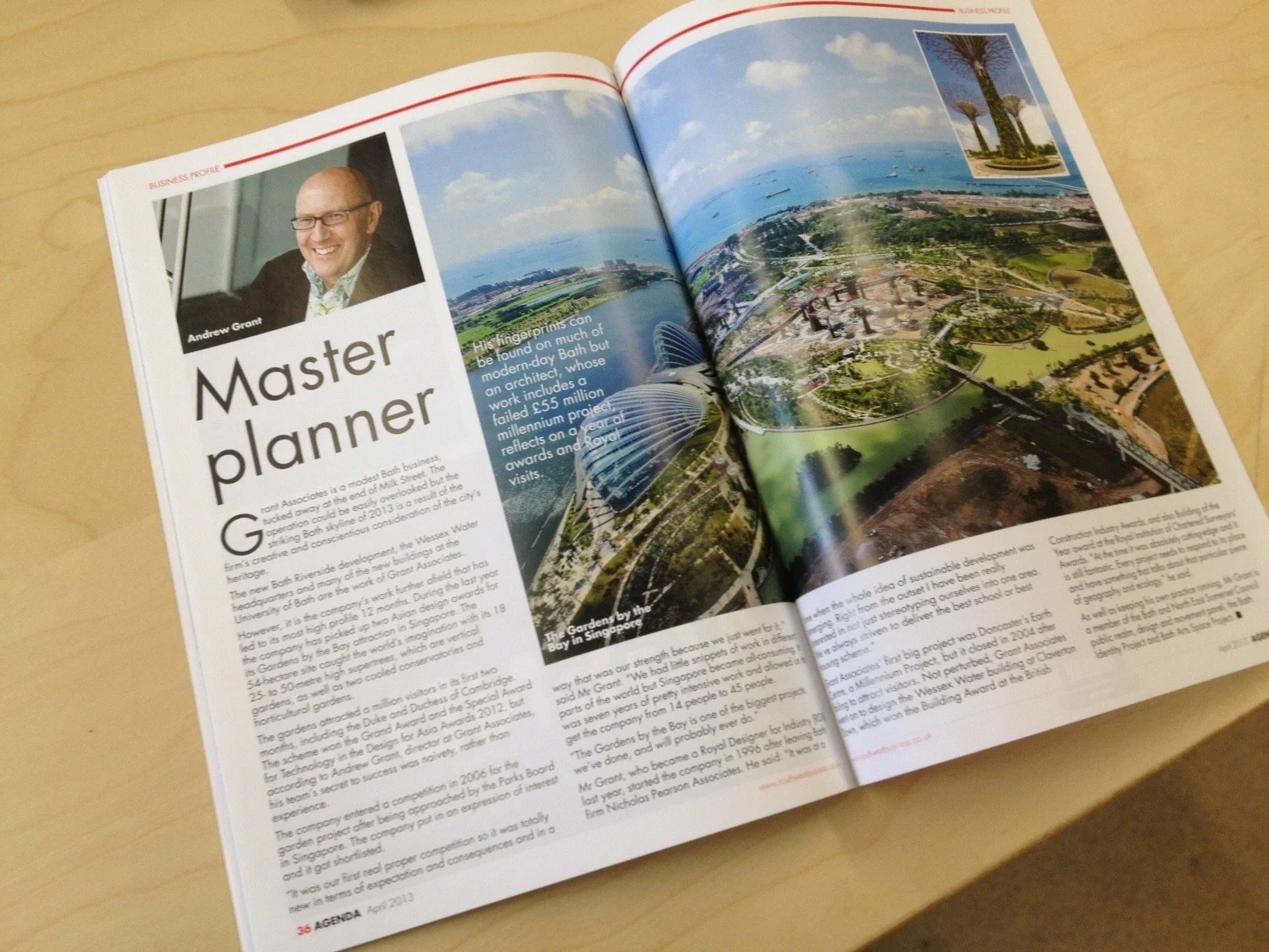 Open magazine featuring a business profile of Andrew Grant, with a large aerial photograph of Gardens by the Bay in Singapore, and a smaller inset photo of palmetto trees.