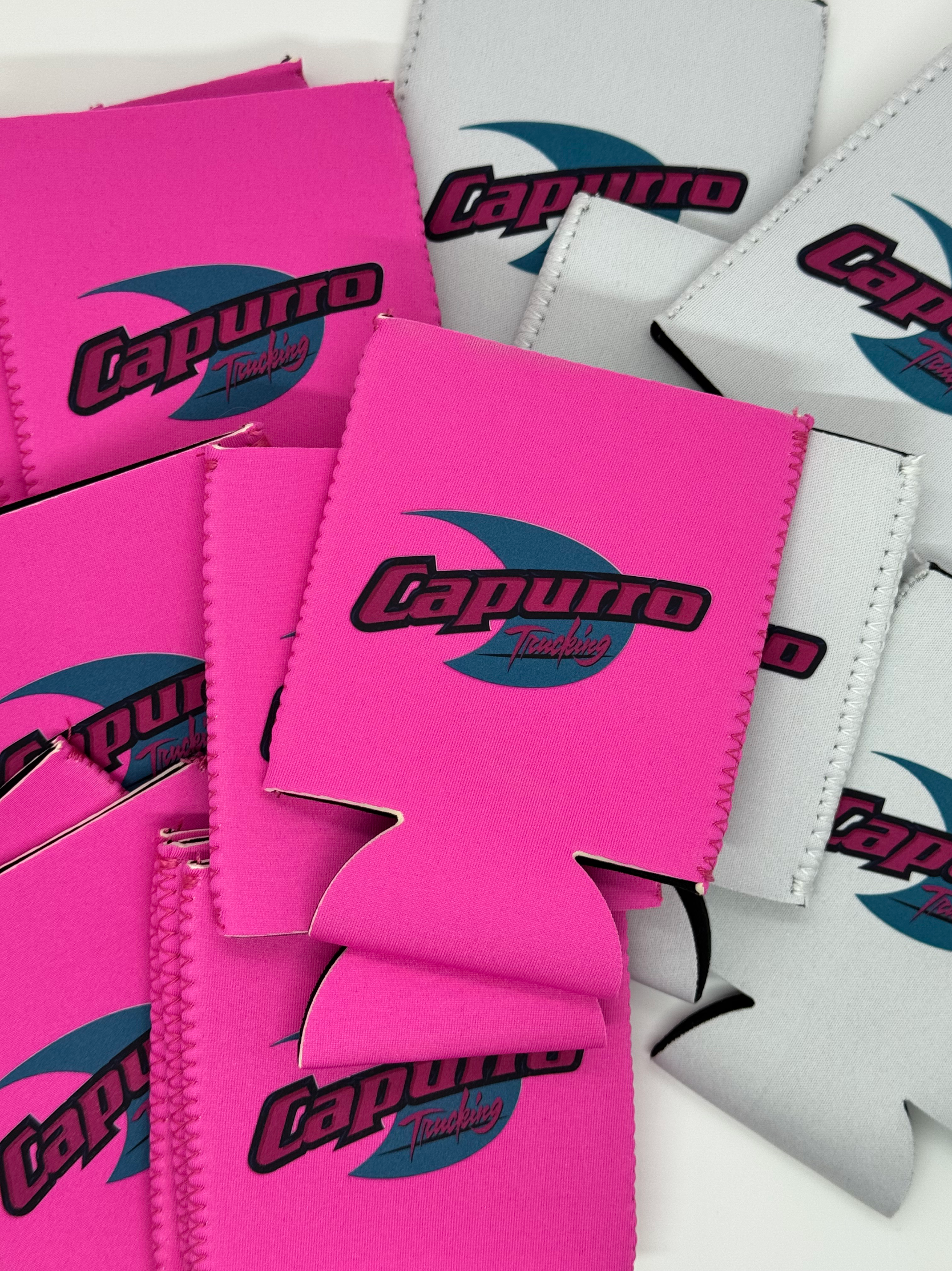 Pink and white patches of fabric with 'Capucho Tuning' logo, some with stitched edges, layered and overlapping.