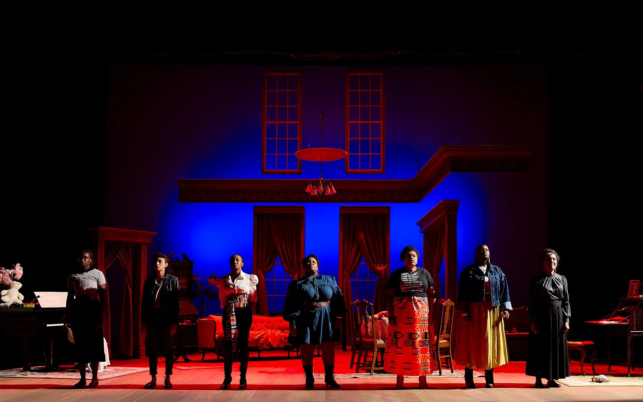 A New Era Production Photo: A group of women in a line, highlight in sharp tones of white and red