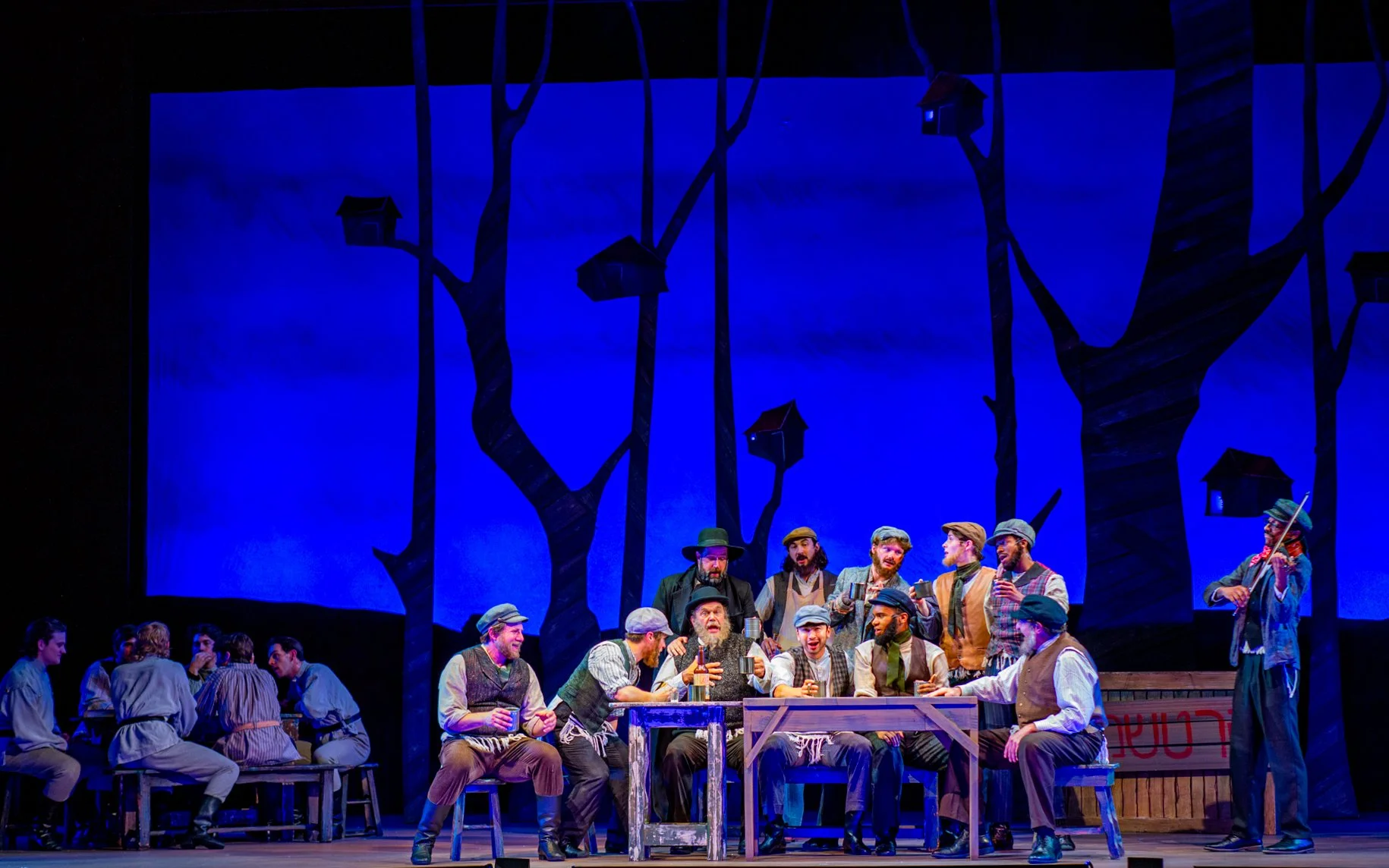 Fiddler Production Photo: A group of men around a table with a night blue background