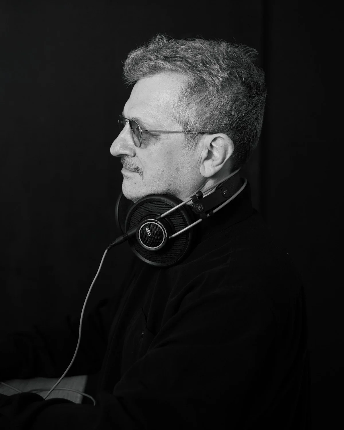 Stefan Elefteriu in profile wearing studio headphones, 2026
