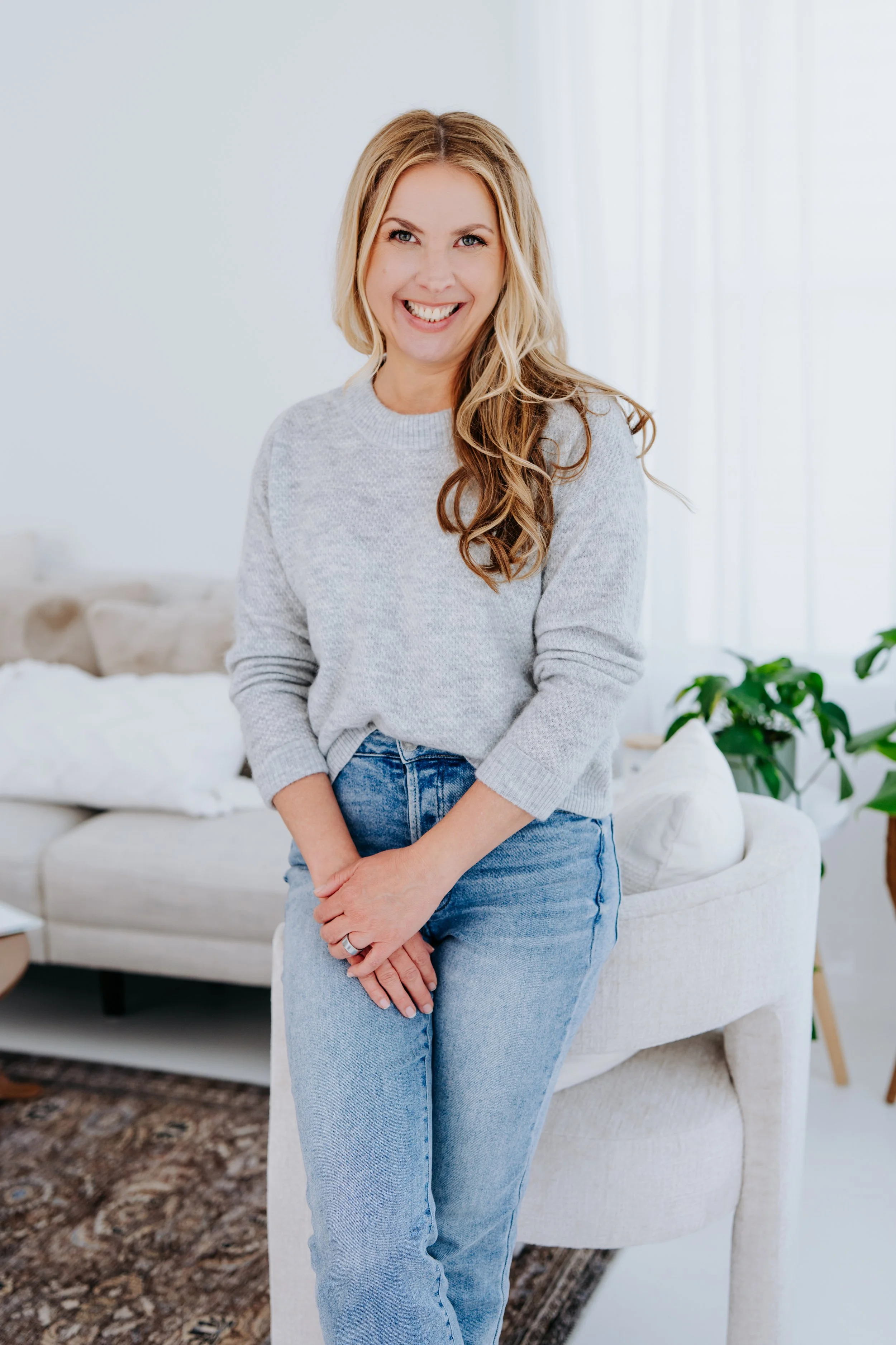Health coach for women smiling at the camera.