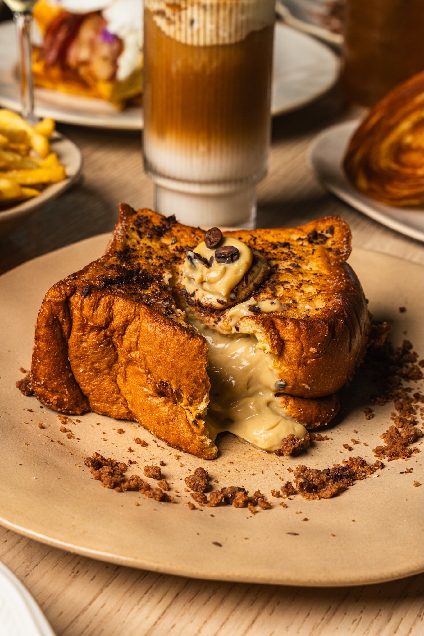 French toast topped with nuts beside an iced latte, café food photography