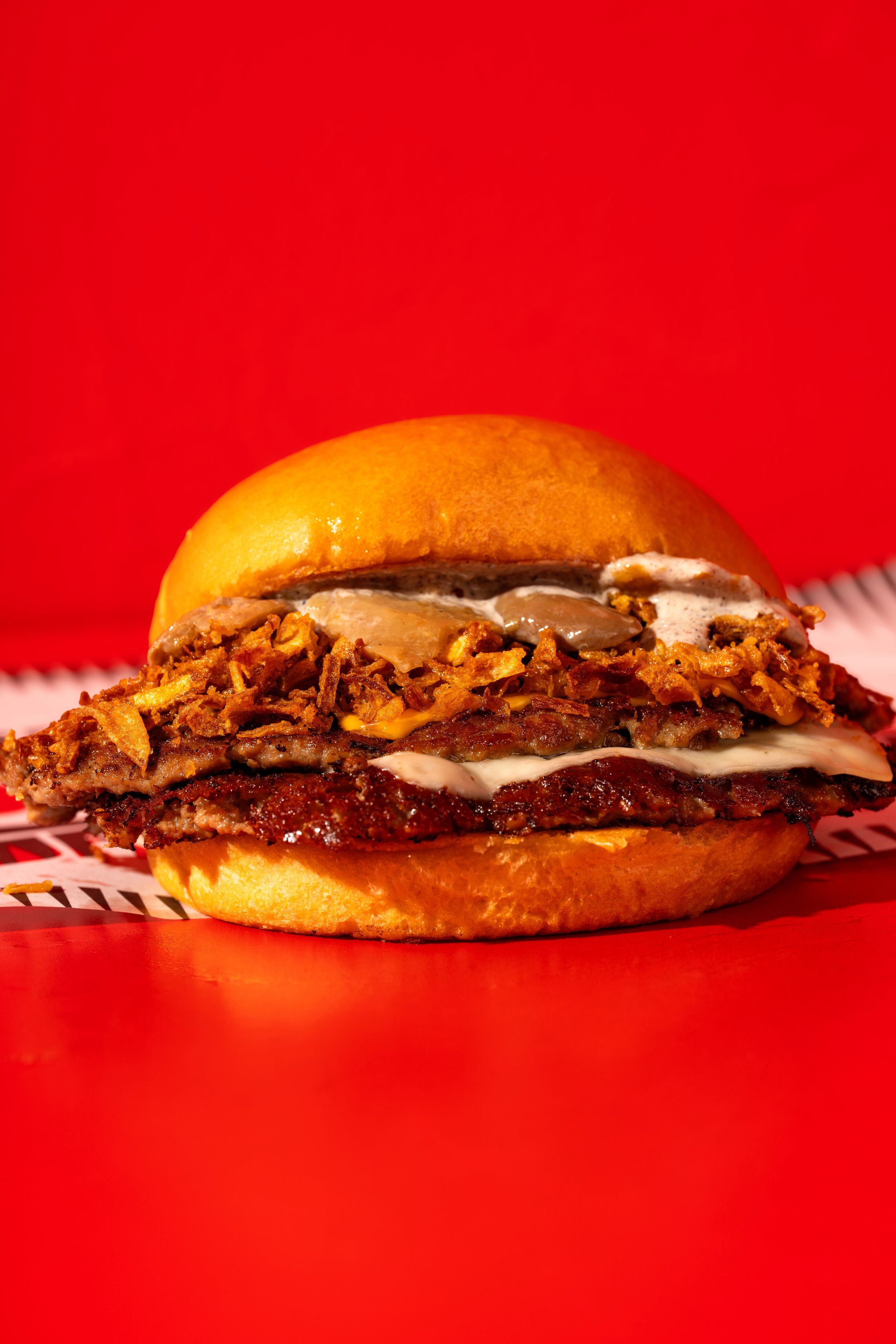 Fried chicken burger on a red background, burger photography Malta
