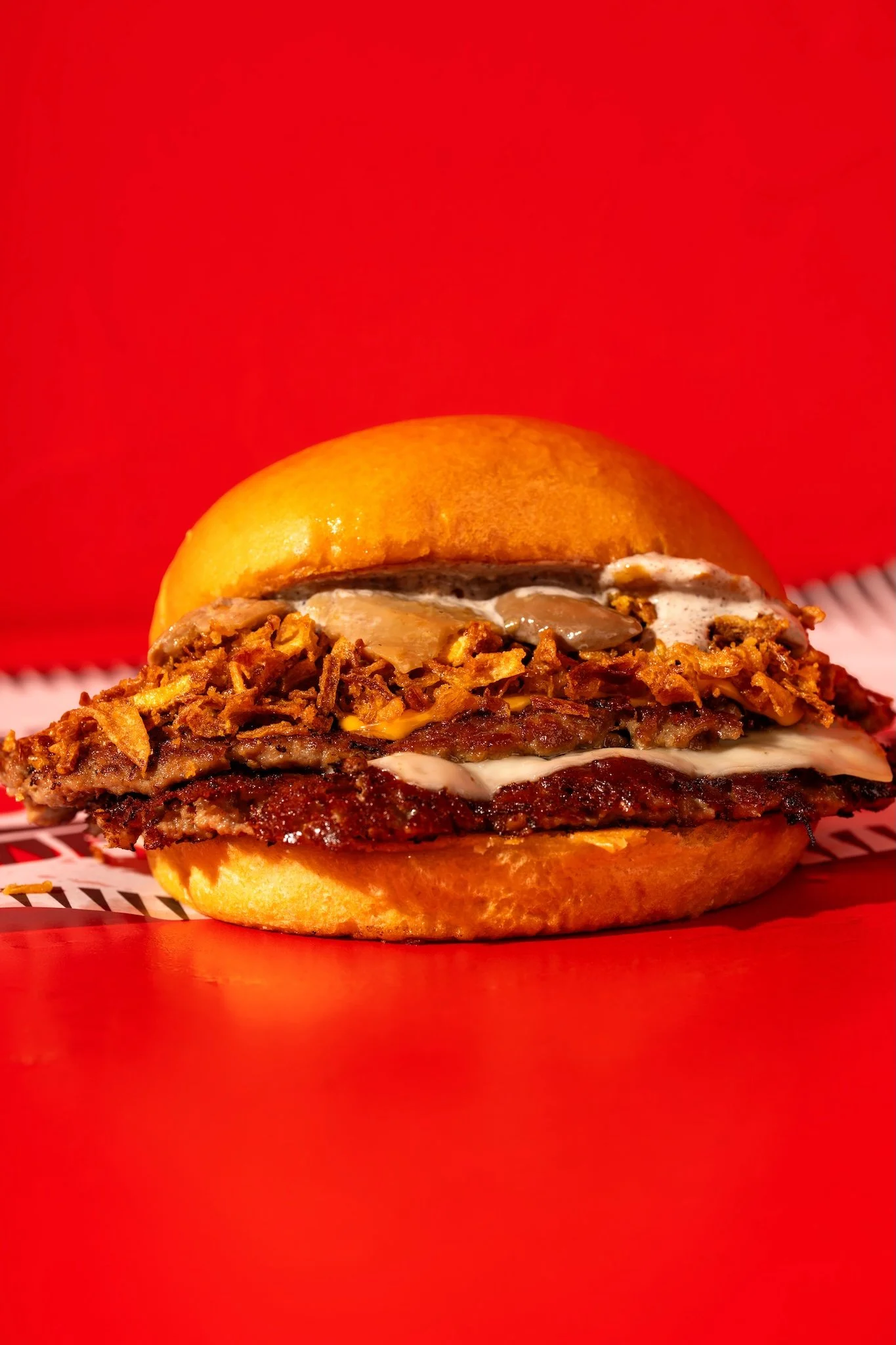 Chicken burger with slaw on a red background, food photography Malta