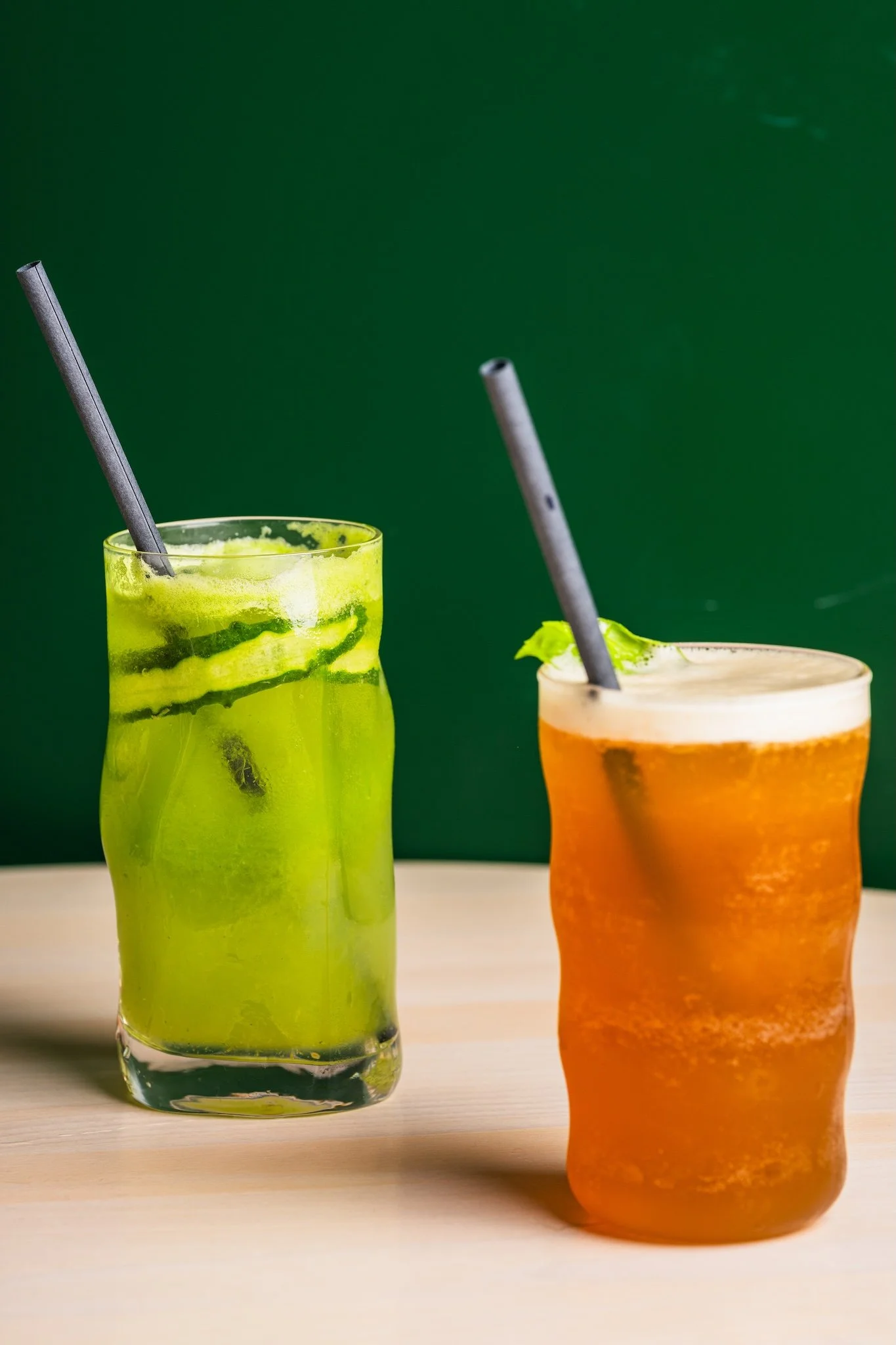 Green and orange cocktails against a green background, cocktail photography Malta
