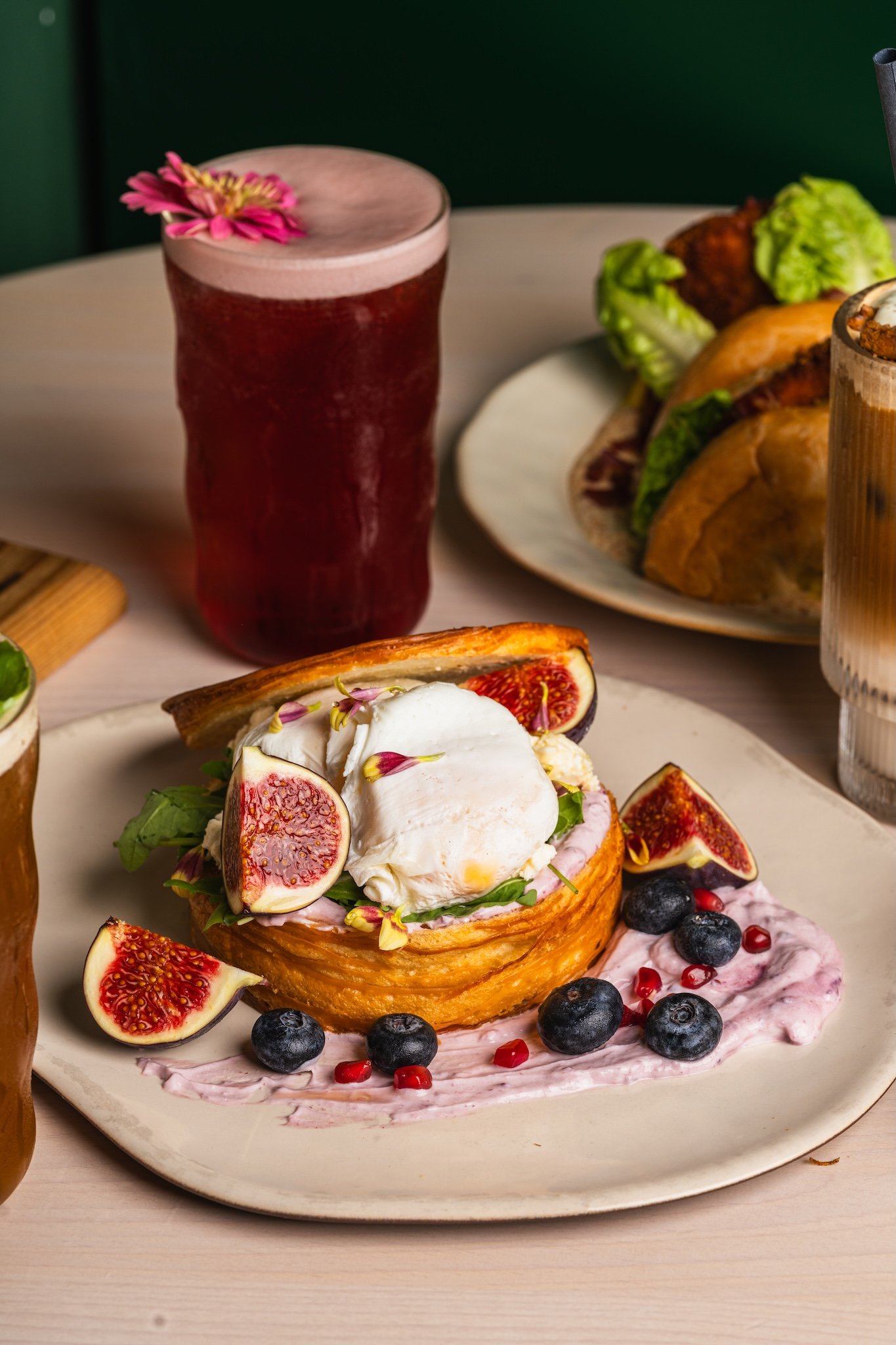 Brunch table with French toast, a burger and a red juice, food photography Malta