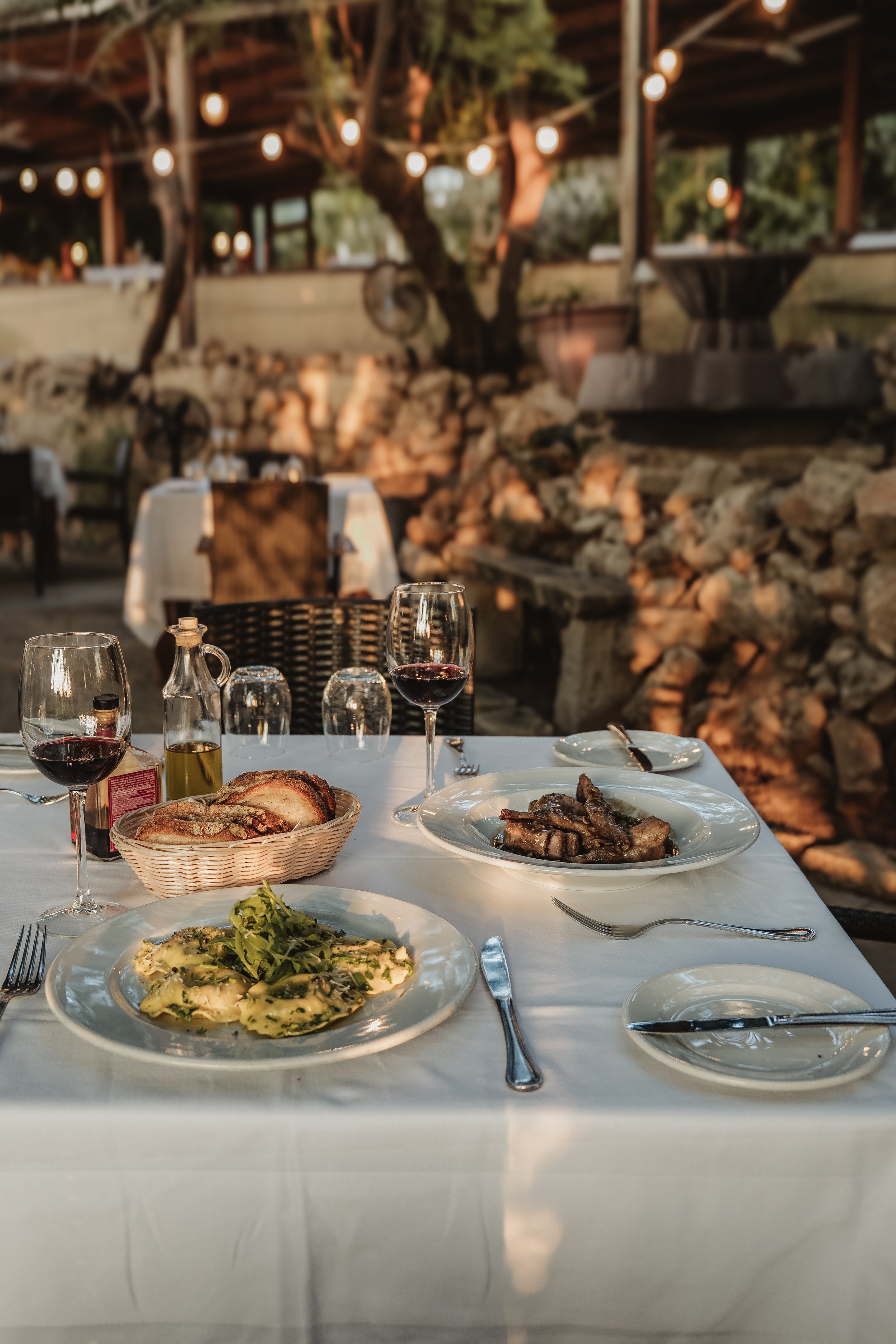 Outdoor restaurant table set for dinner at dusk, venue photography Malta