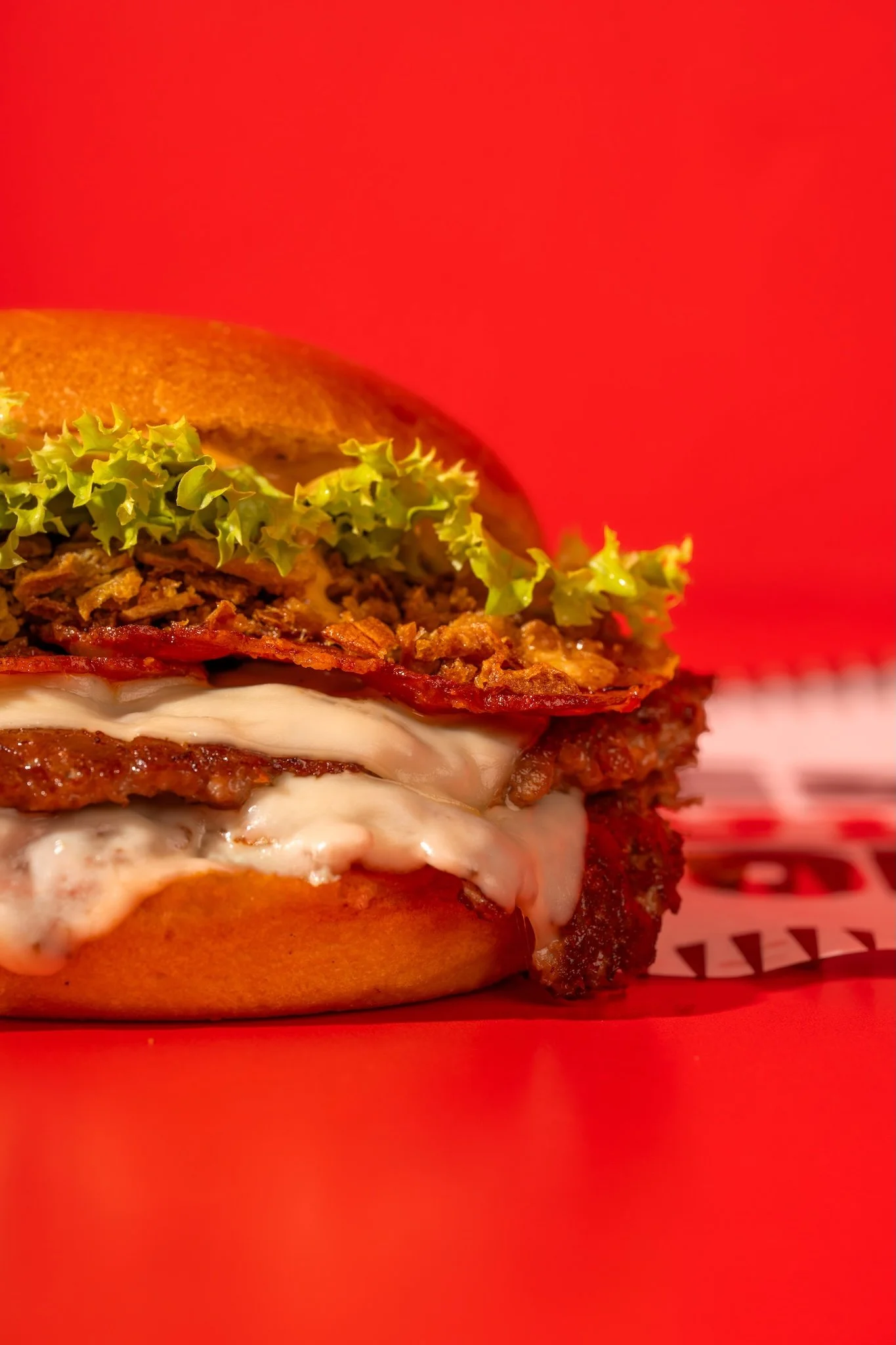 Burger with lettuce and sauce on a red background, burger food photography