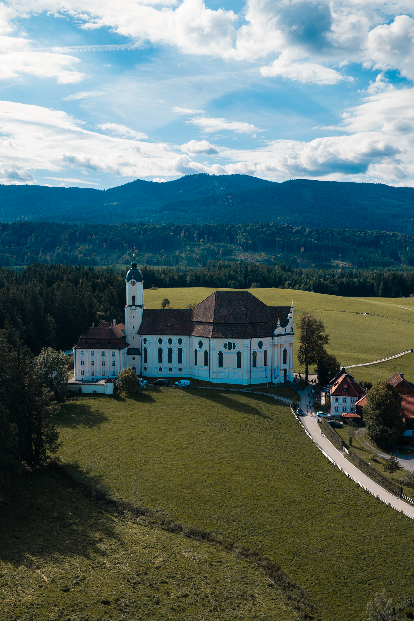 Aerial drone photograph of a white church in green countryside