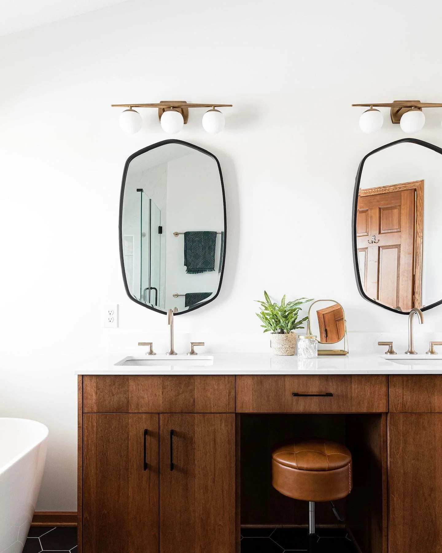 Dark. Moody. With a pop of greenery amongst the white. Are we describing the current MN scene out the window or this beautiful mid century bath remodel we just completed with @willabyway ?!