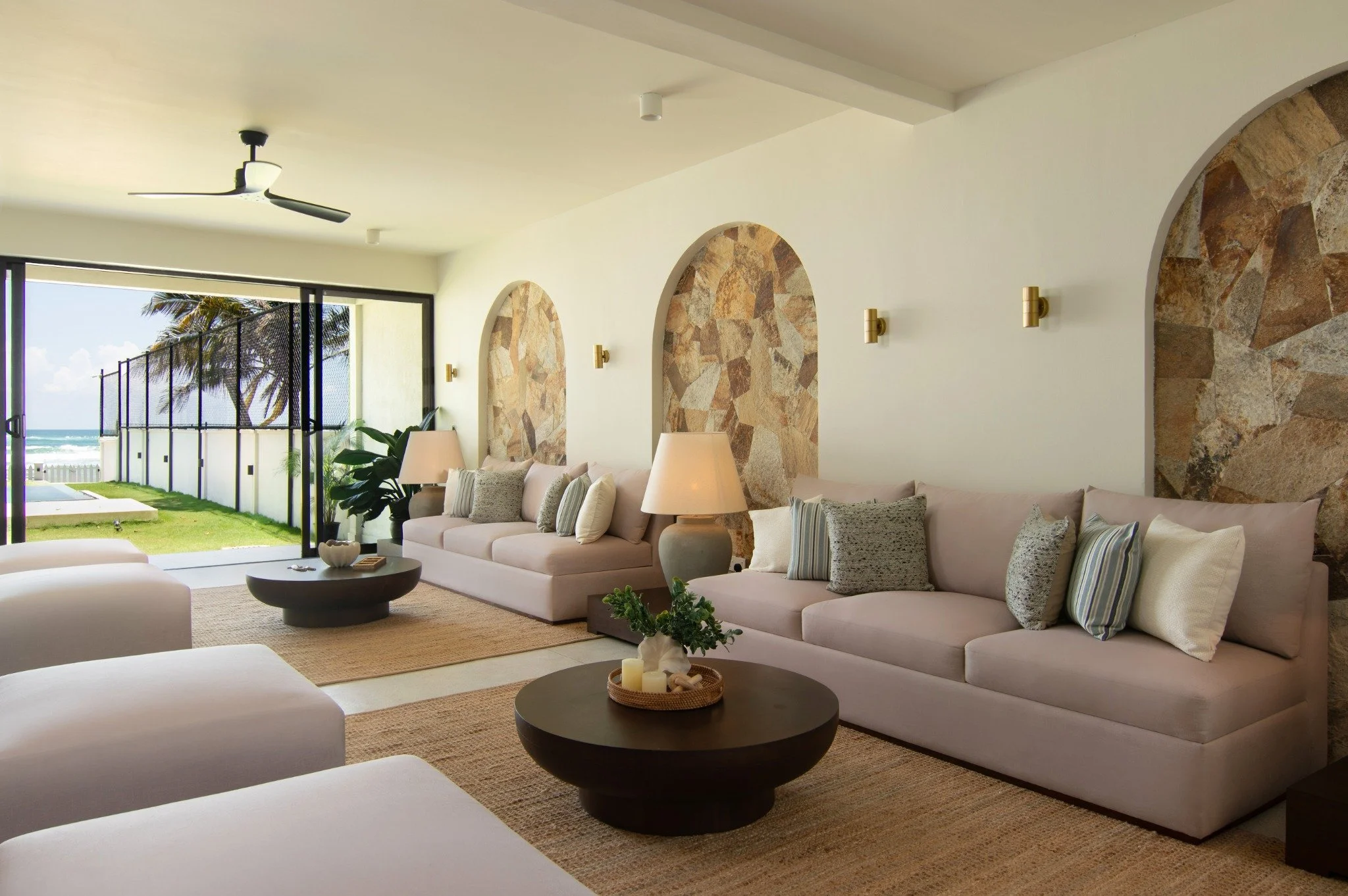 SAYU’s lounge with soft seating, tropical plants and ocean views.