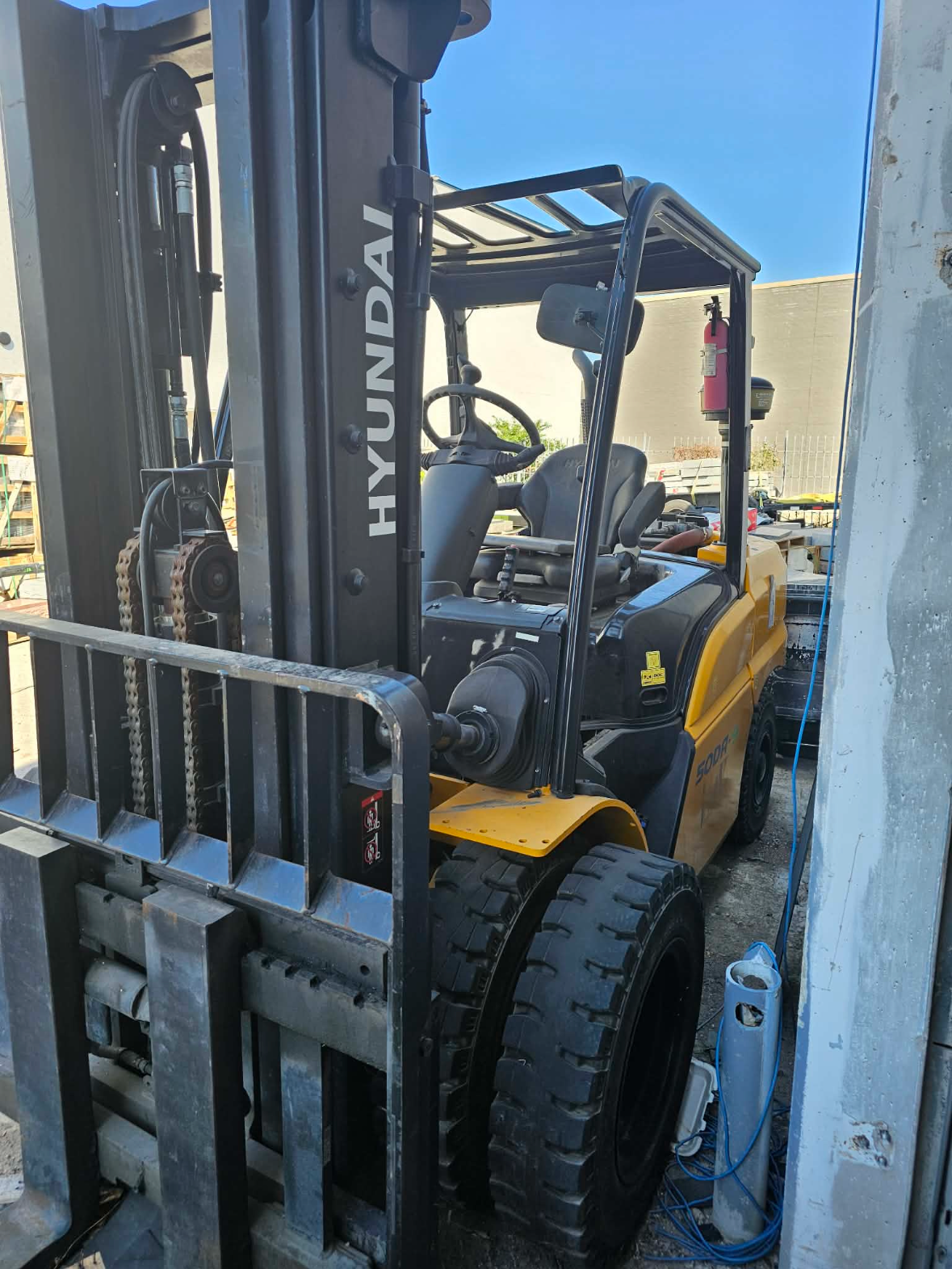 Hyundai forklift parked in an industrial loading area.