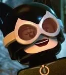 Close-up of a LEGO character with dark hair, sunglasses, and a smiling expression