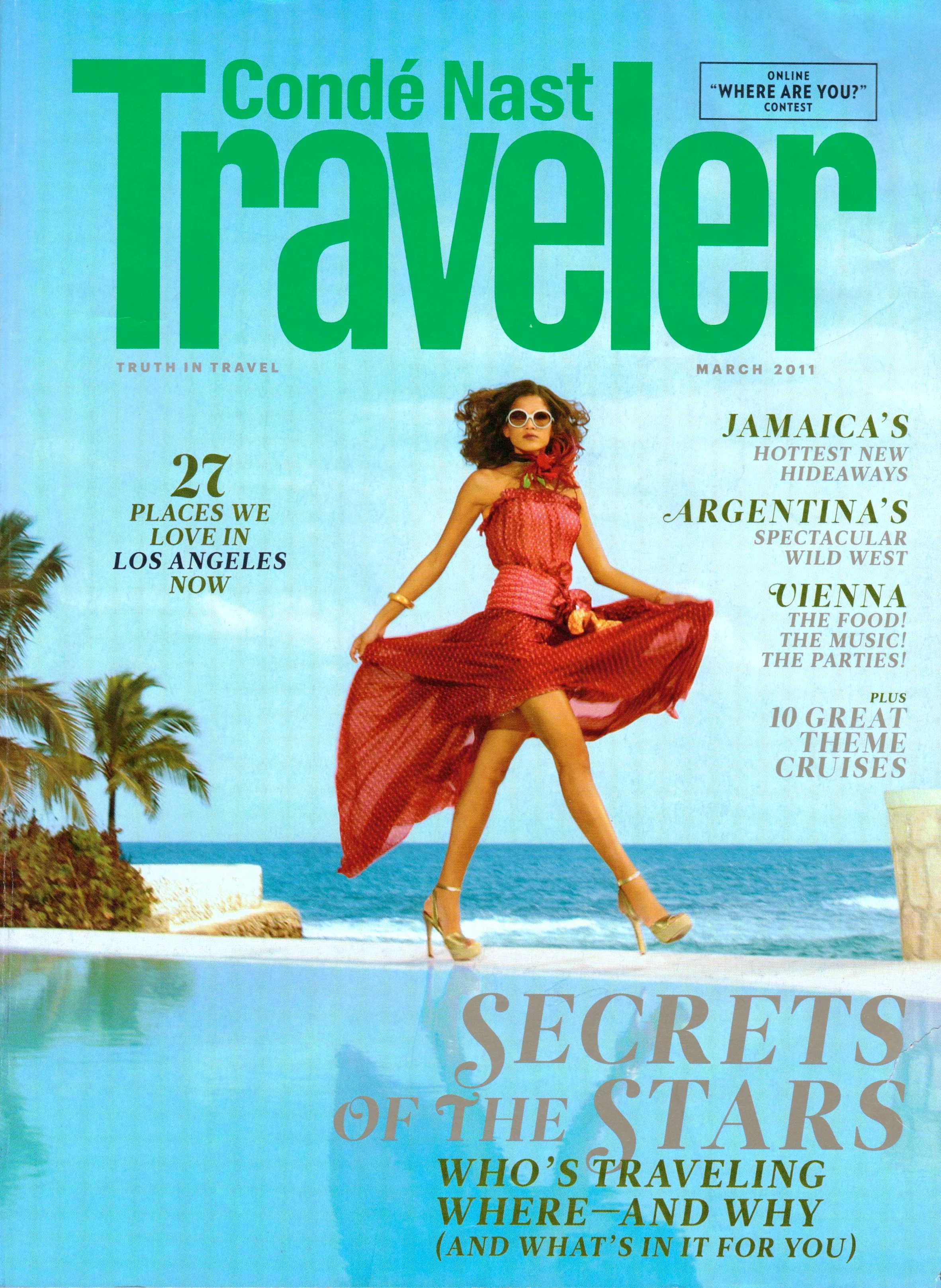 Magazine cover from March 2011 featuring a woman in a red dress and sunglasses posing on a beach with palm trees and the ocean in the background.
