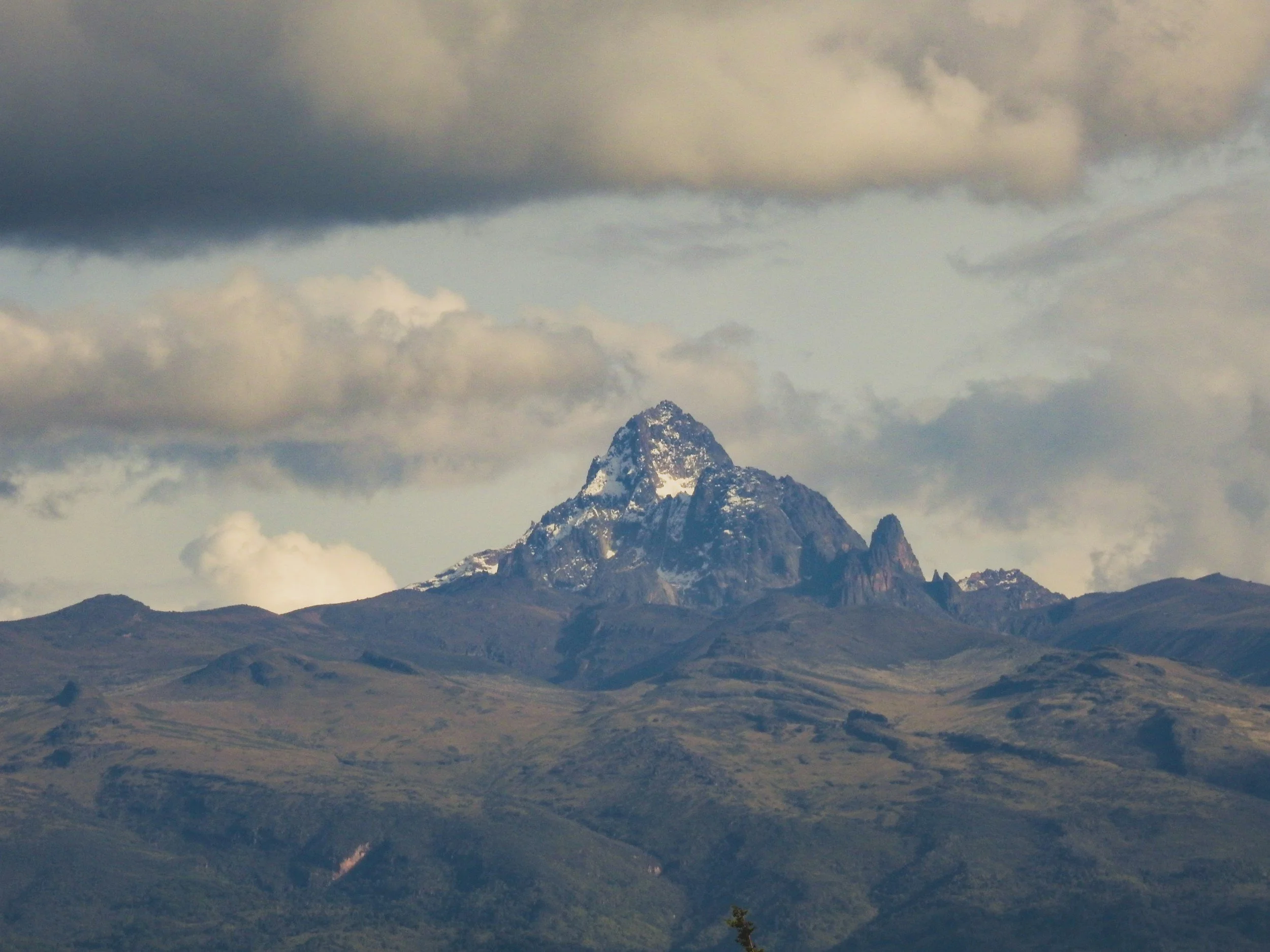 Mount Kenya above its green lower slopes