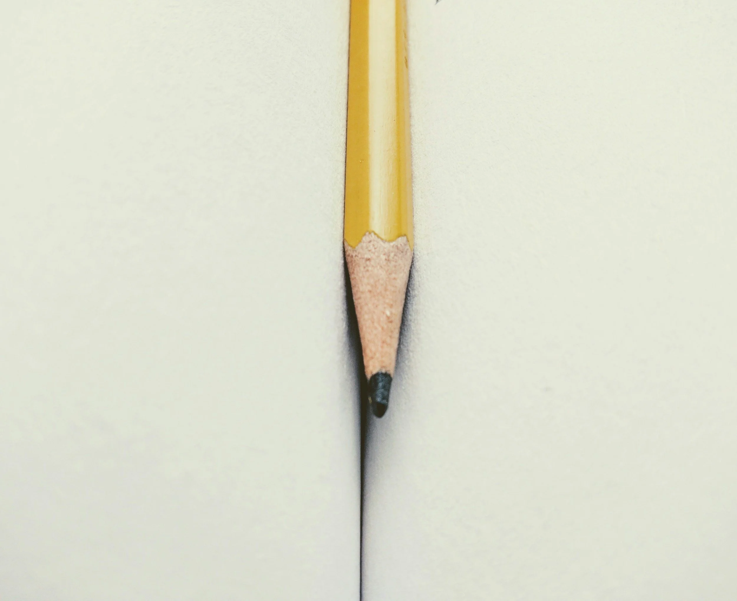A sharpened pencil on a blank page