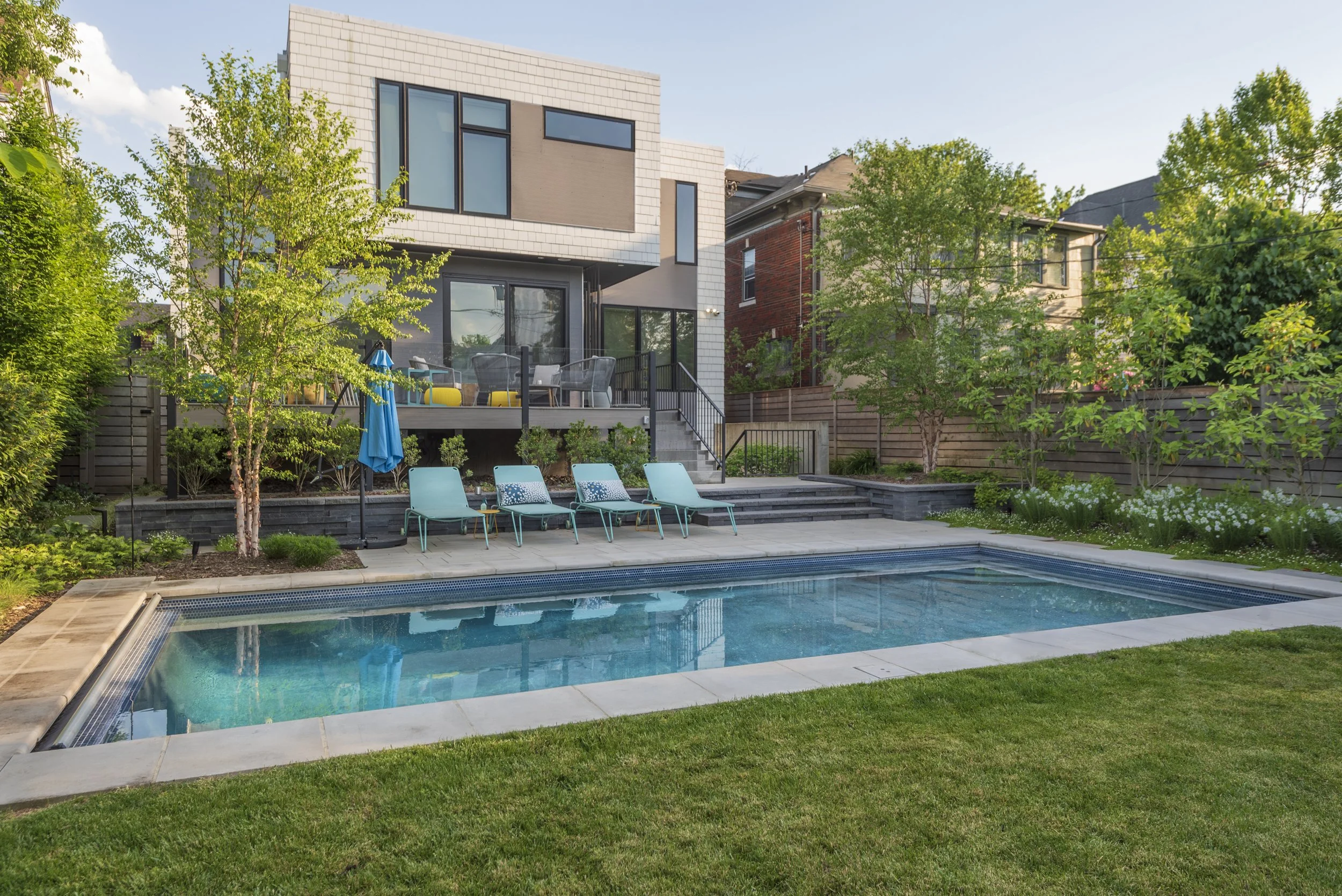 DC Midcentury modern design in Crestwood/Petworth DC. Swimming pool, screening plantings, lawn play area, pool patio. Concrete paver walls, patio, and walkways.