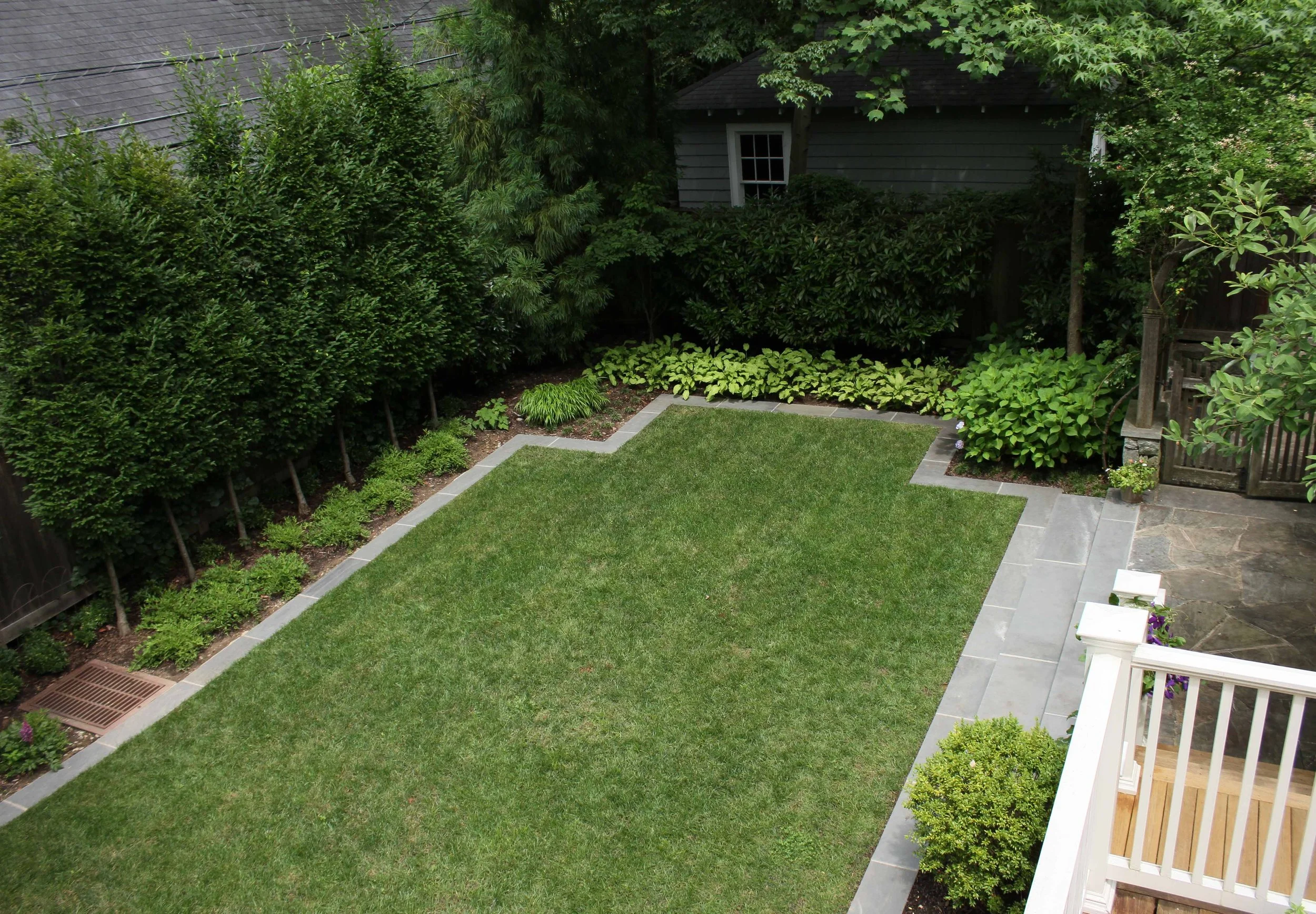 Geometric design for a lawn play area. Natural PA Bluestone framed lawn area. Clean line garden design Chevy Chase, MD