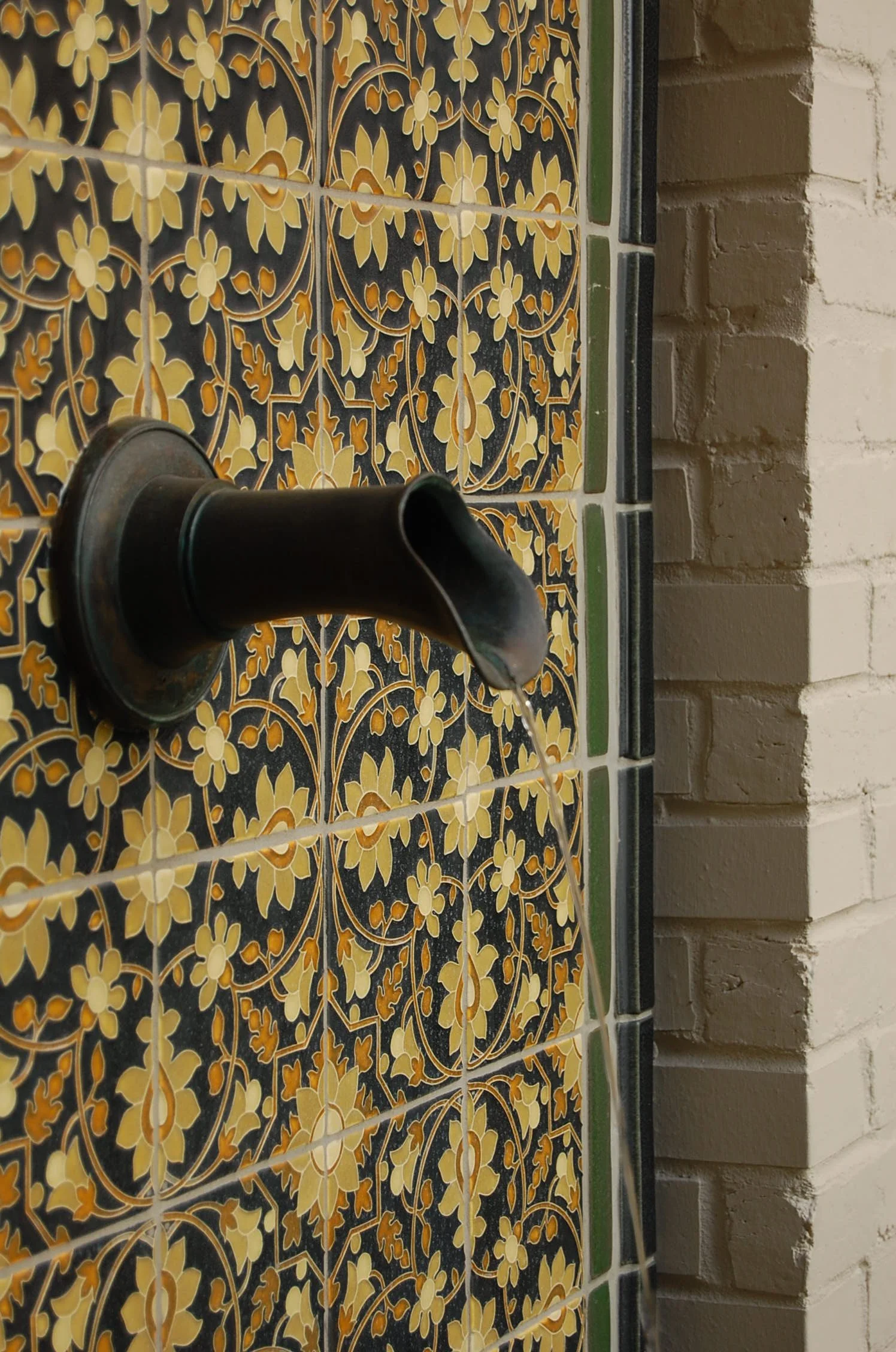 Detail of a custom water feature with bronze spout and colorful Motawi tiles. New design for an Art Deco home in Kalorama, DC