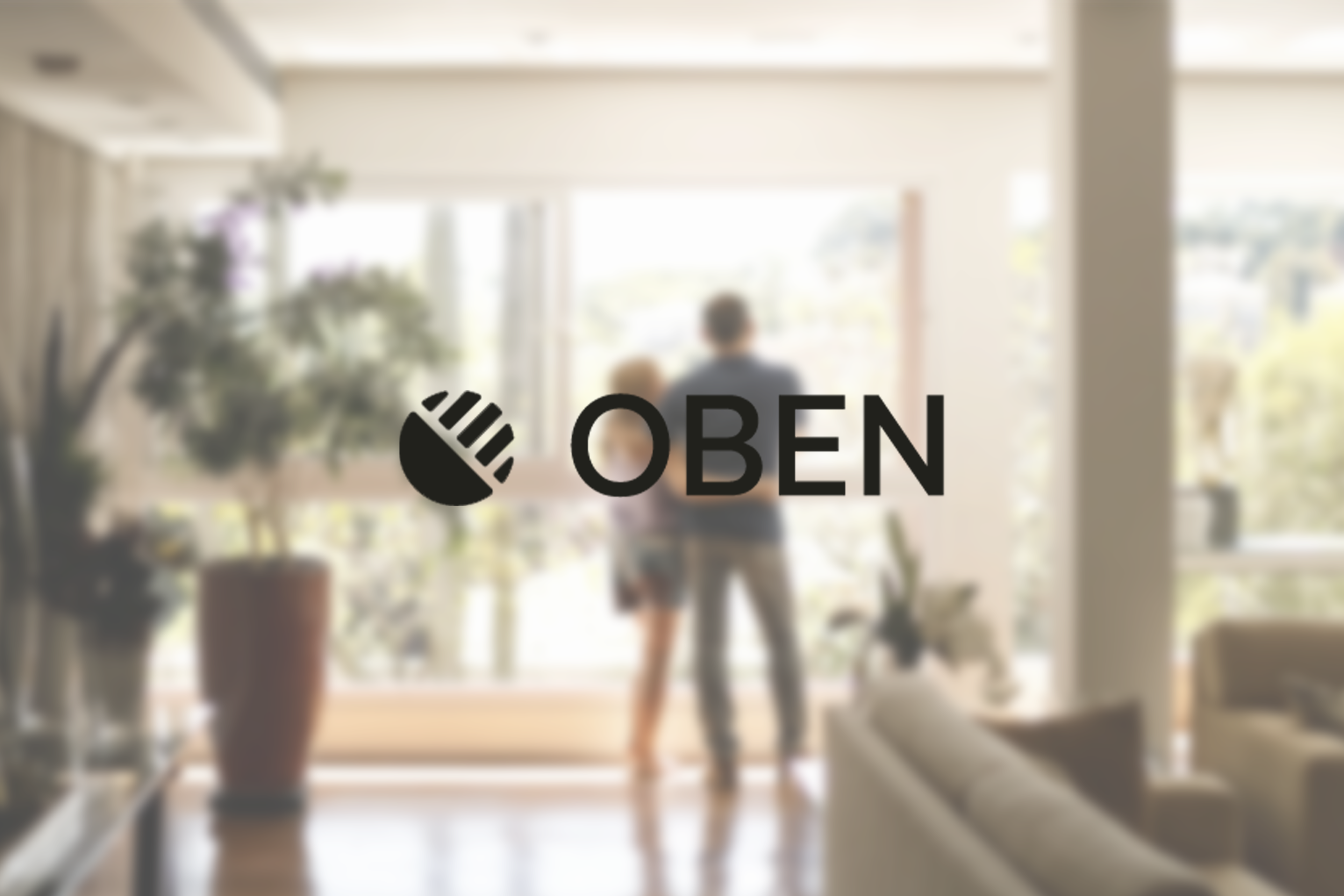 Blurred image of a person walking into a sunny room or patio through glass doors, with a potted plant on the left side, and a woman with short hair wearing a dark shirt and light-colored shorts.