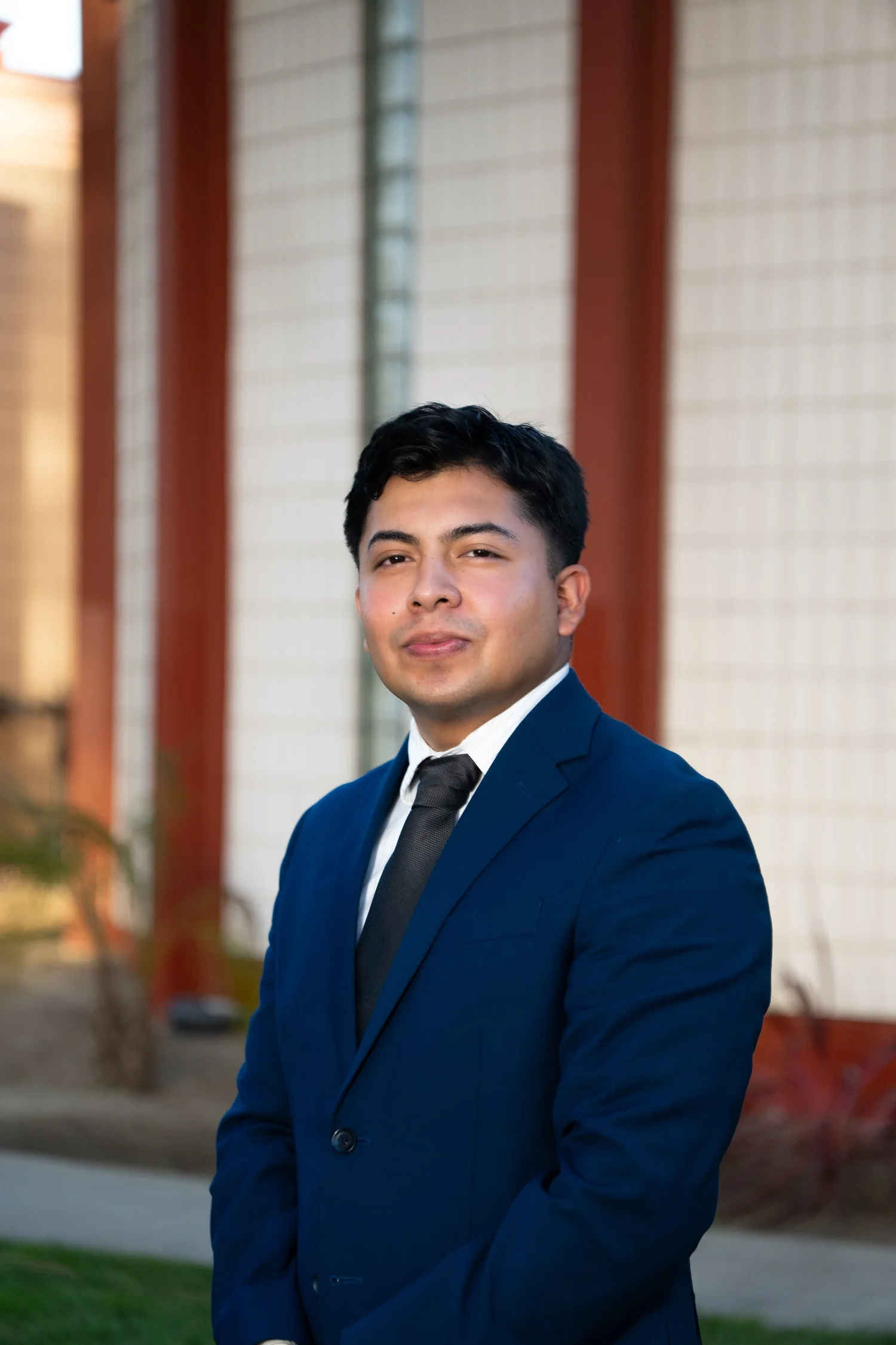 Samuel Perez wearing a navy suit outdoors.