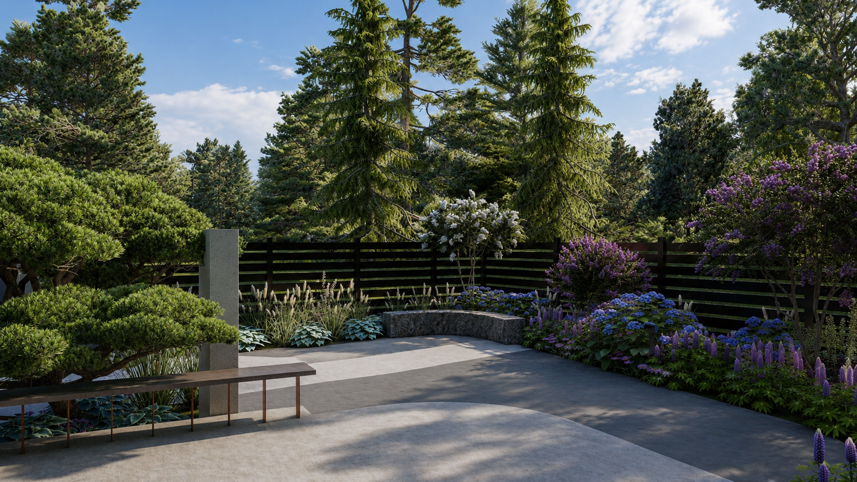 A modern landscaped backyard garden with a concrete patio, a curved stone bench, and an assortment of lush green shrubs, tall pine trees, and colorful flowering bushes, enclosed by a black wooden fence under a partly cloudy sky.