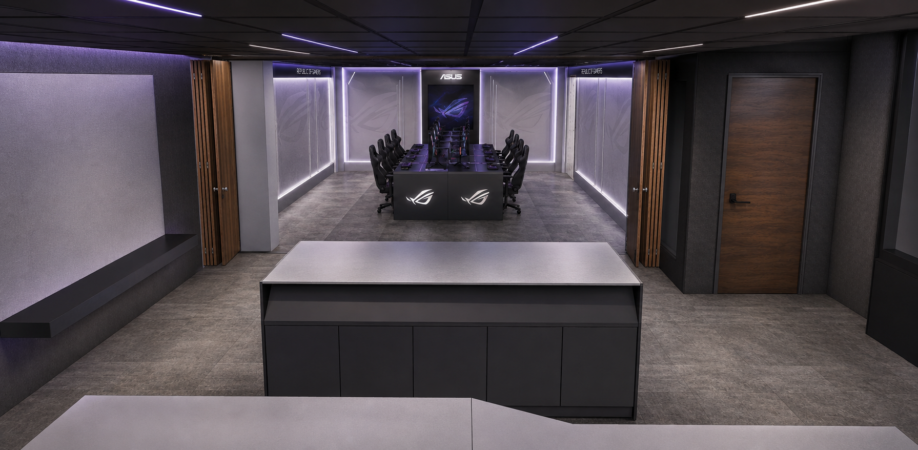 A modern gaming or office room featuring a conference table with multiple gaming or office chairs, illuminated ASUS and Republic of Gamers logos, and ambient purple and white lighting along the walls and ceiling.