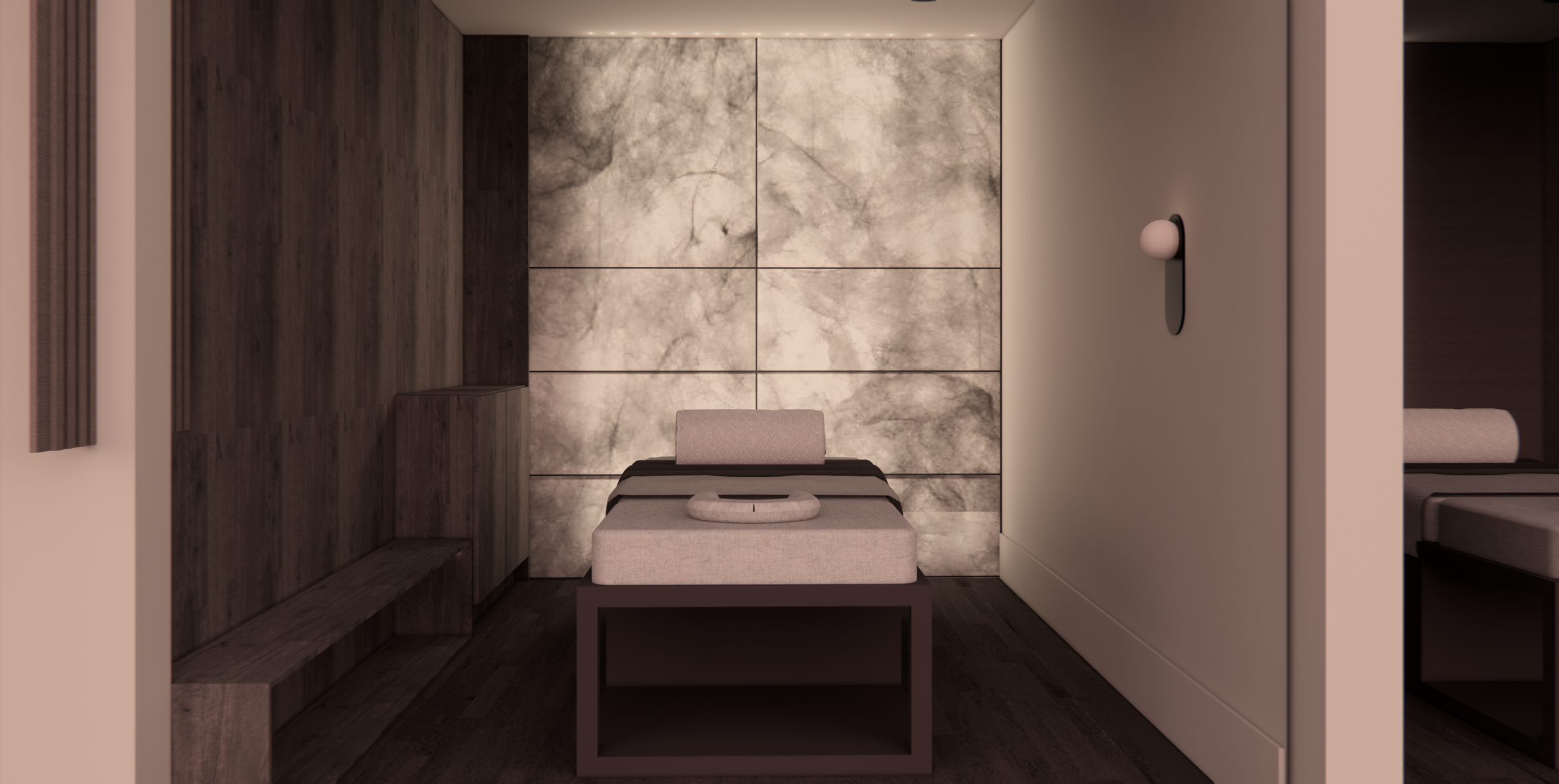 A massage or treatment room with dark wood paneling and gray marble wall tiles, featuring a massage table with a headrest in center, a small white blanket, and a white pillow. There is a small wooden bench on the left and a white cabinet on the right with a black wall-mounted light fixture above it.