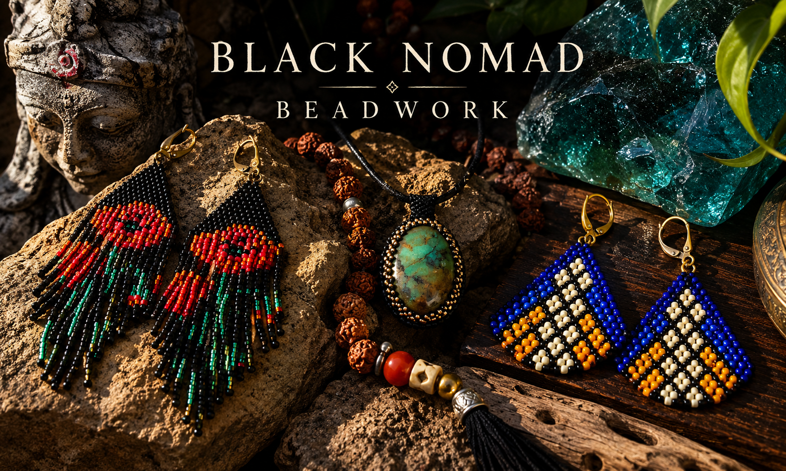 Beaded earrings, pendant necklace, and jewelry displayed on rocks and wooden surface, with a stone sculpture and blue gemstone in the background, at Black Nomad Beadwork.