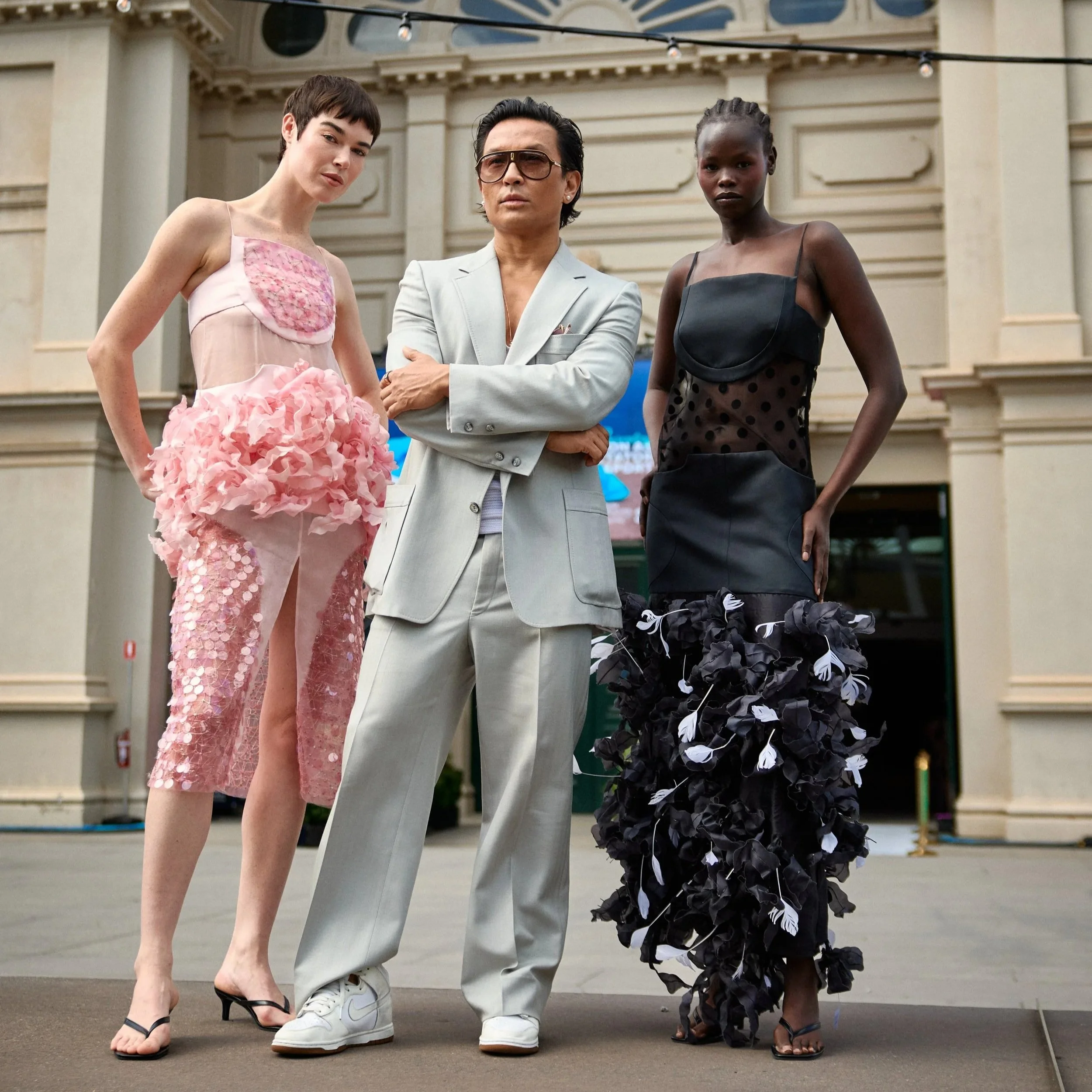 Models flanking designer Prabal Gurung at PayPal Melbourne Fashion Festival 2026.