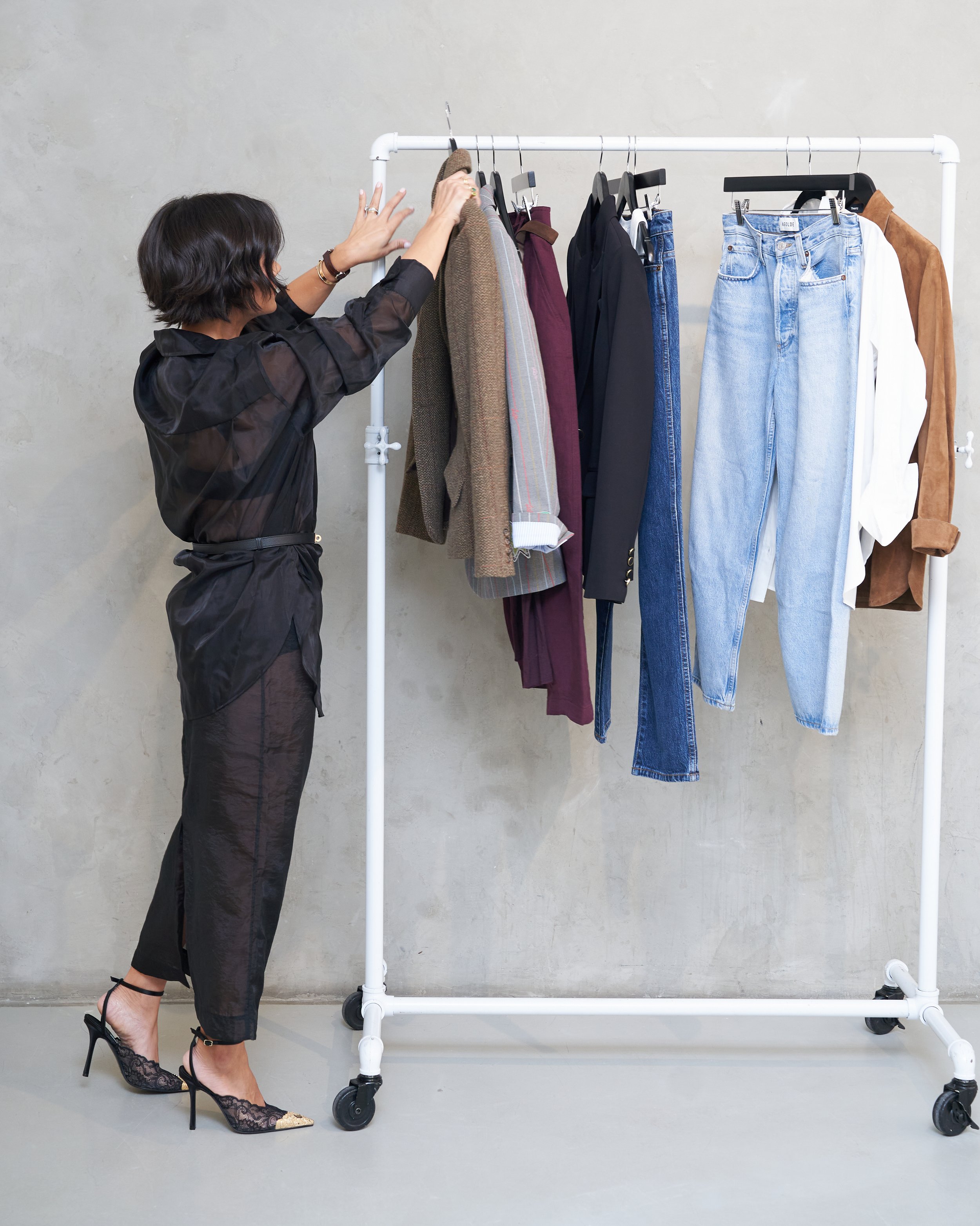 Melissa of Styled by Meeshamore editing a clothing rack during a wardrobe edit