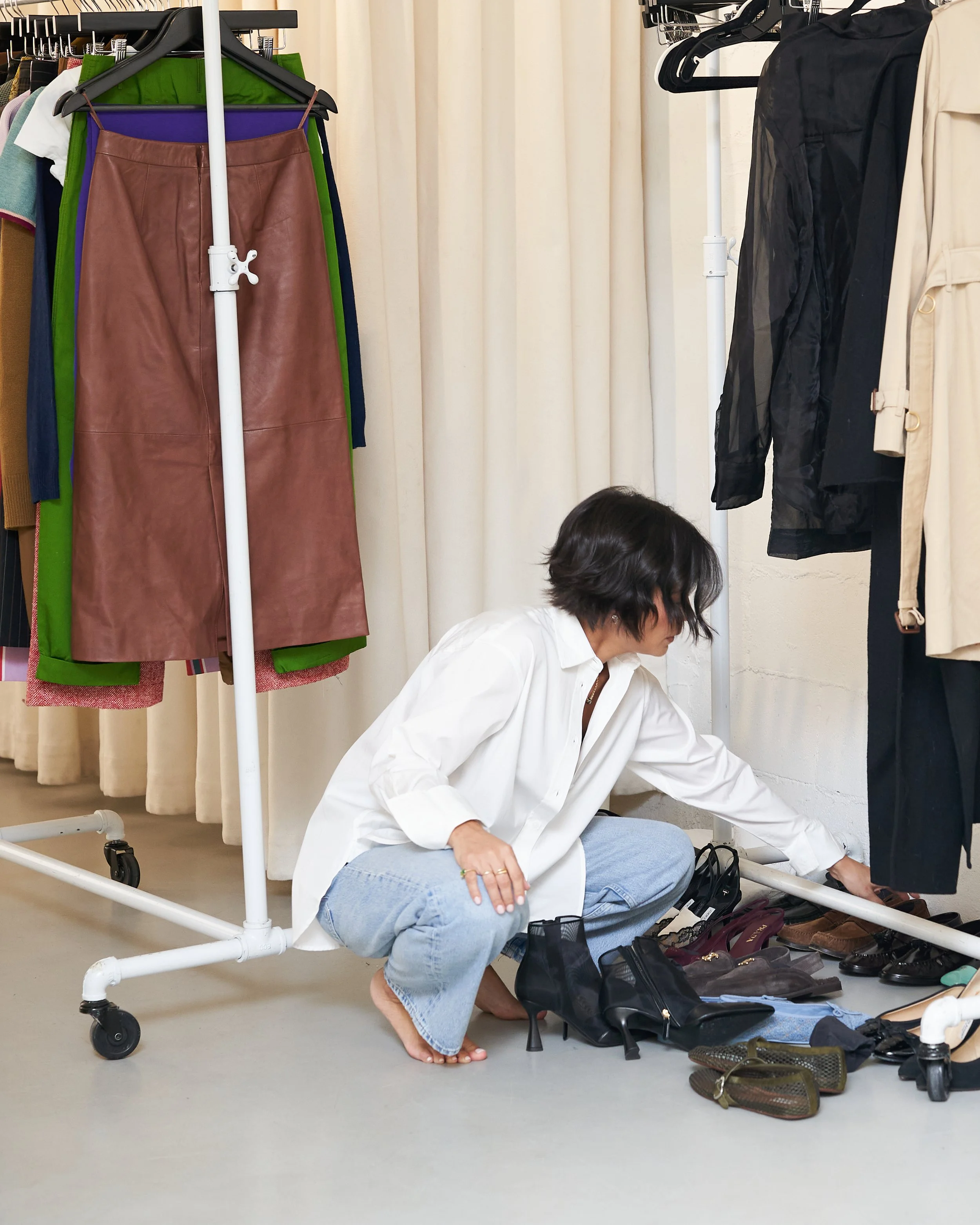 Melissa of Styled by Meeshamore sorting shoes and clothing during a personal styling session