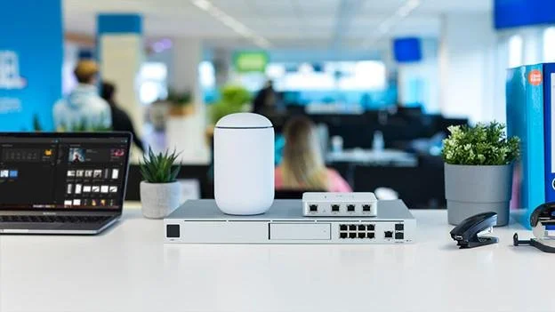 Business networking equipment featuring a UniFi wireless access point, network gateway and Ethernet switch.