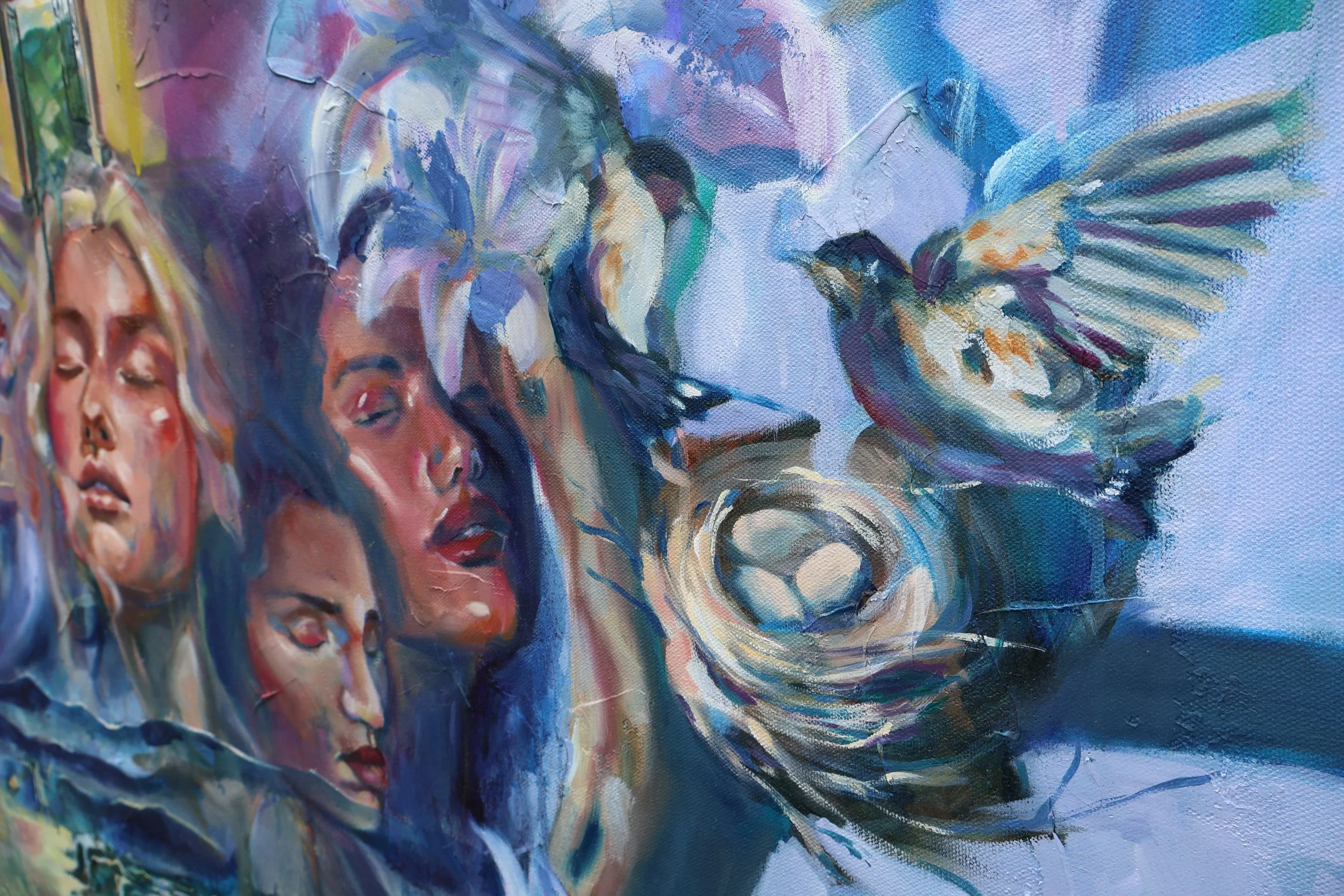 Close-up of a colorful abstract painting featuring overlapping human faces and a large blue-and-purple flower.