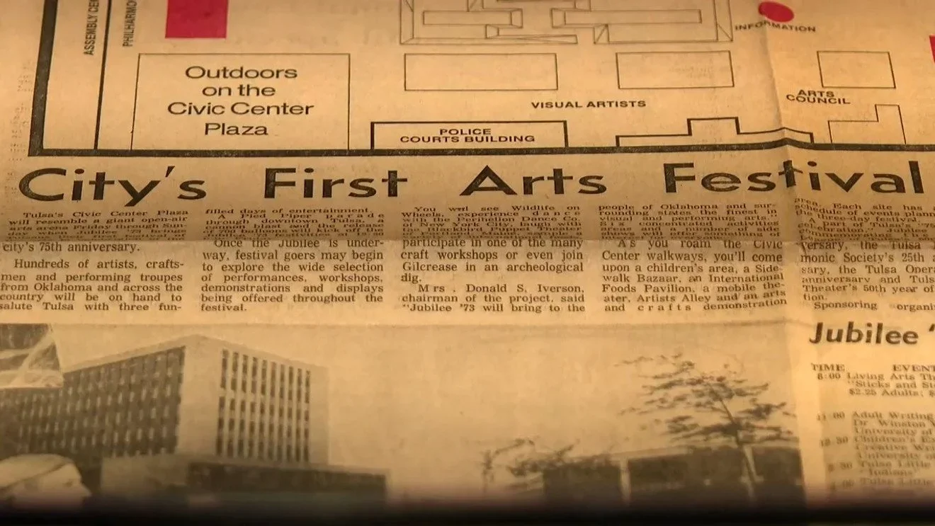 Close-up of a newspaper article titled 'City's First Arts Festival' with a map of Tulsa's Civic Center Plaza and a partial photo of a building.