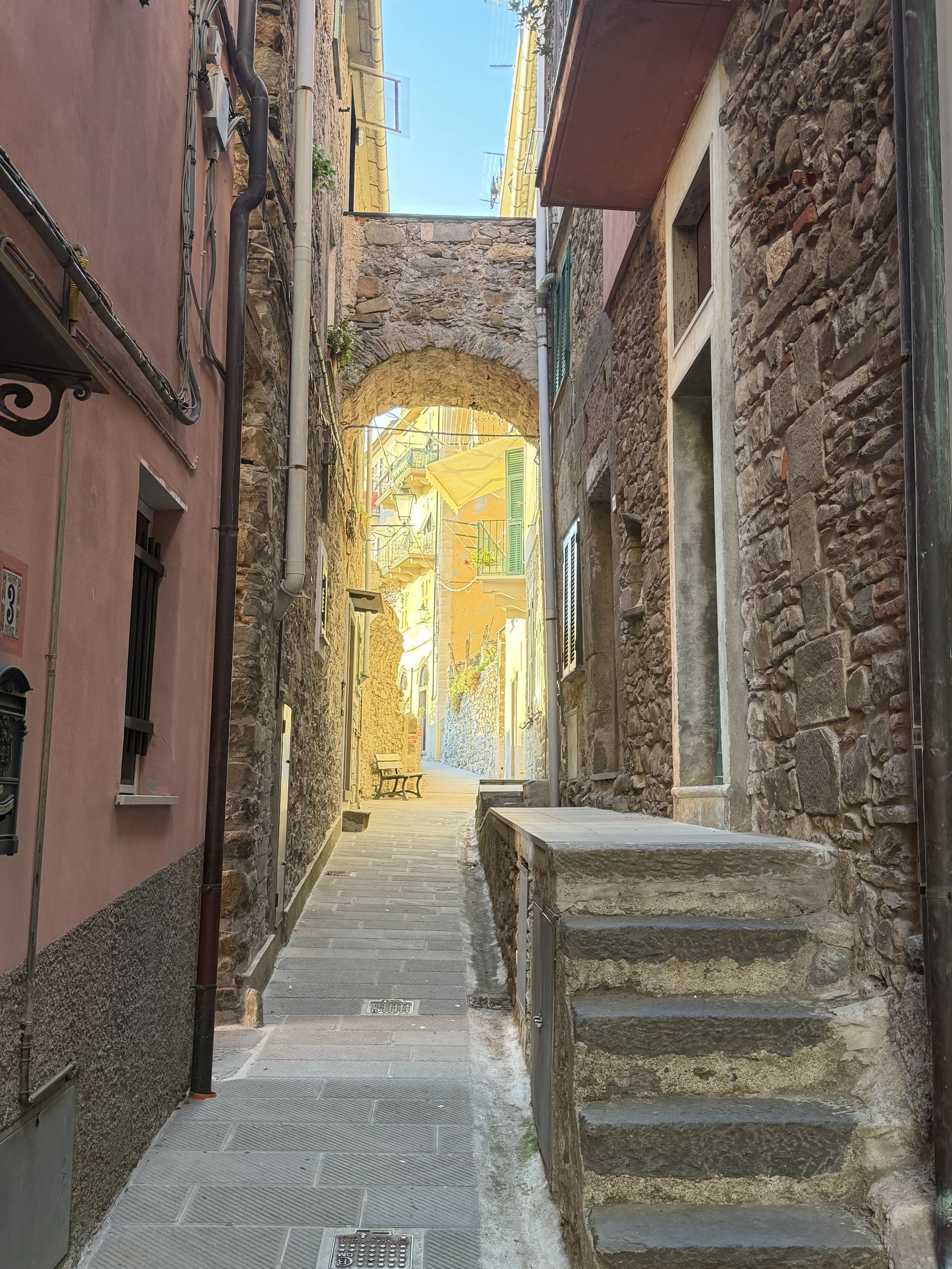 A narrow old stone alleyway of Cinque Terre. during golden hour.