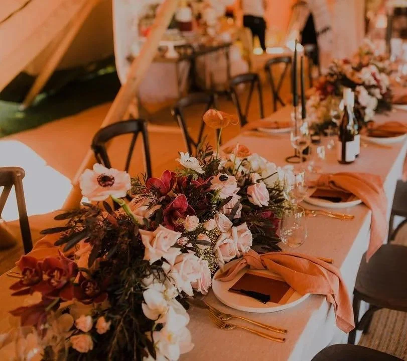 Wedding tables laden with fresh flowers as centerpieces.