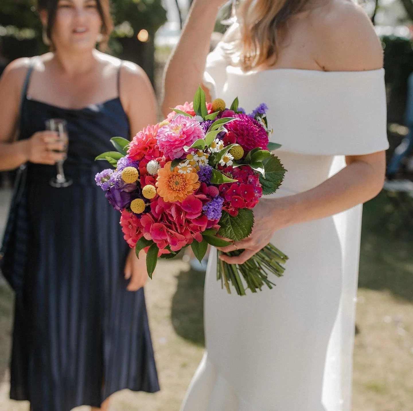 Bridal bouquet of bright flowers. Fuschias and purples and yellows flowers.