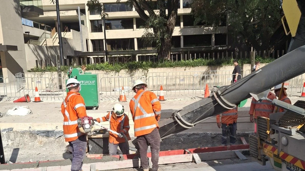 Workers in hard hats and hi-vis on site