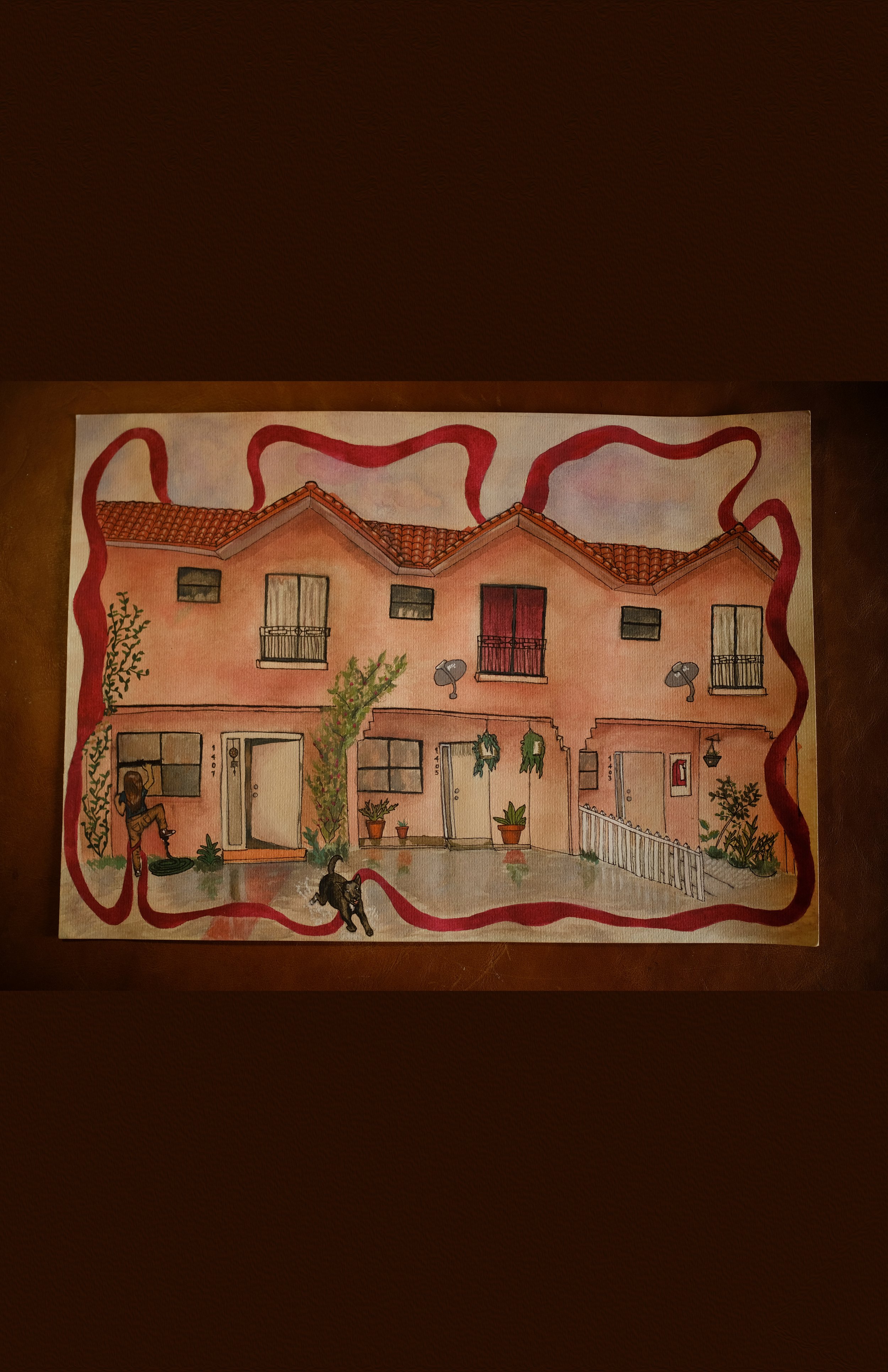 Colorful illustration of a row of three pink houses with tiled roofs, small balconies, windows, and doors, surrounded by plants, trees, and outdoor furniture.