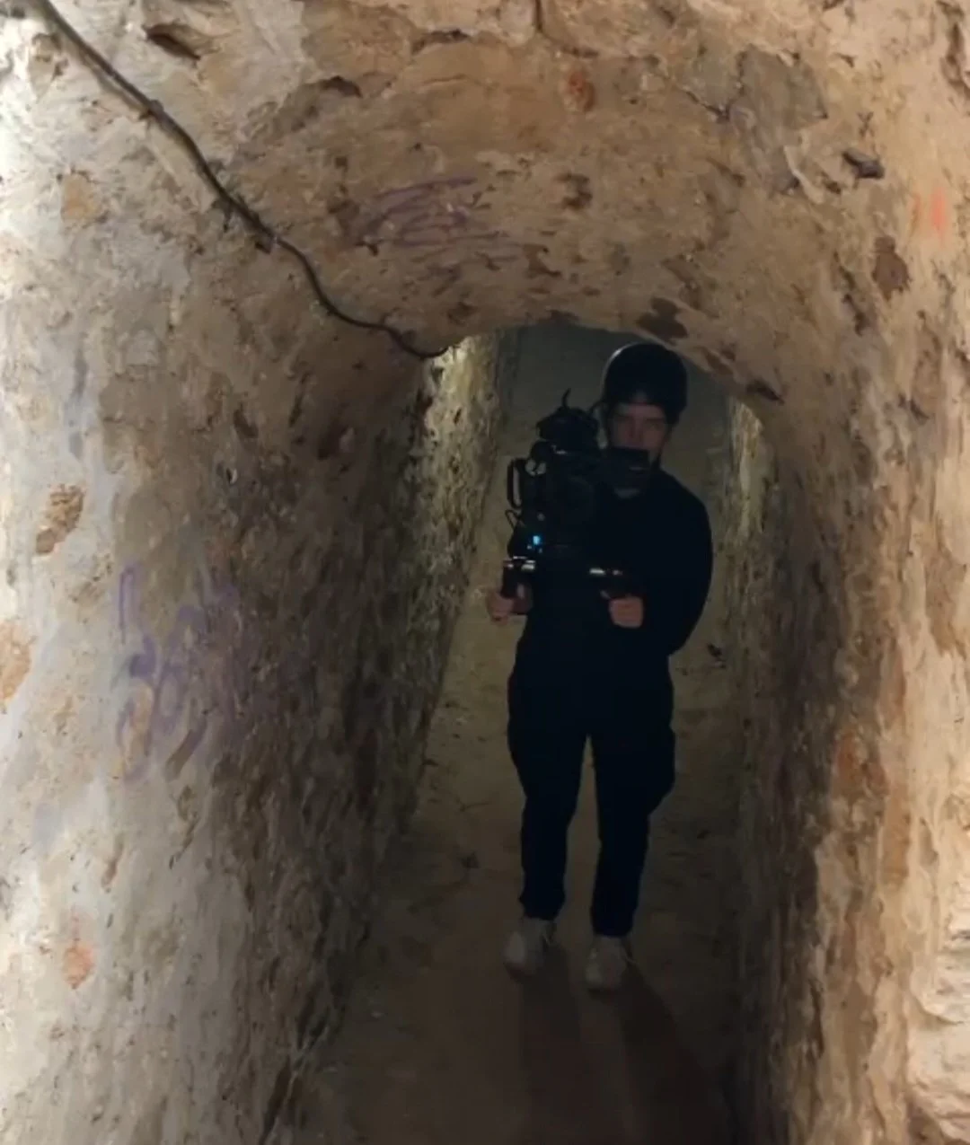 Person holding camera on shoulder