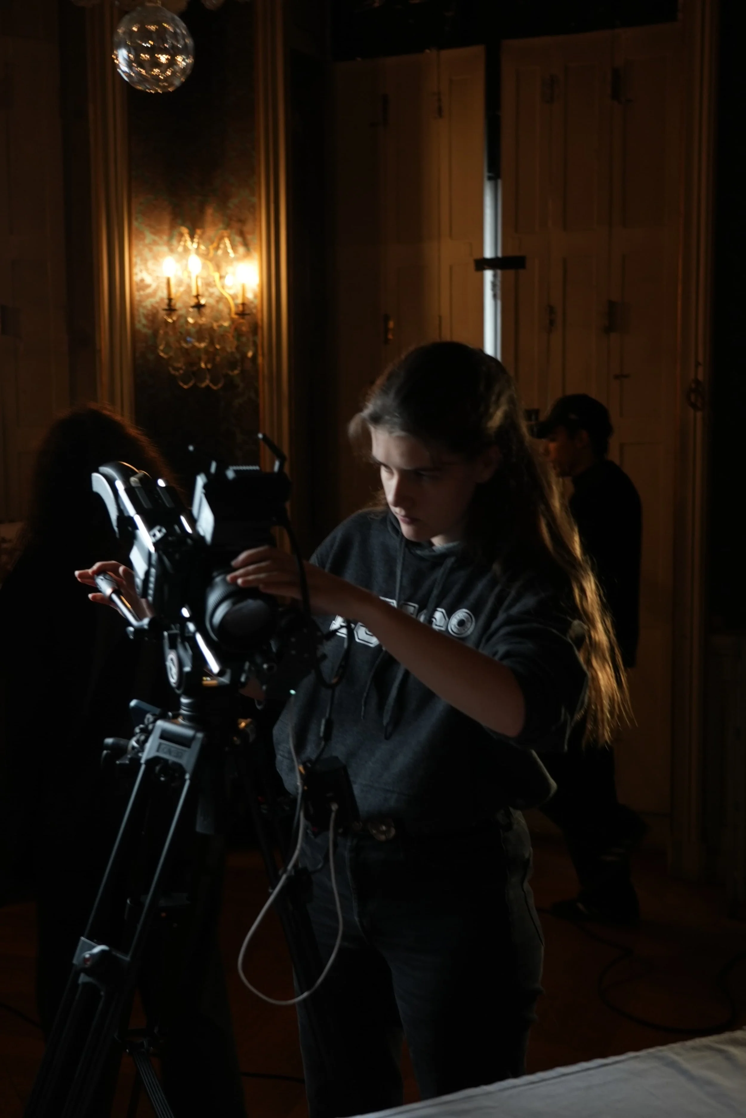 Person working on camera on tripod