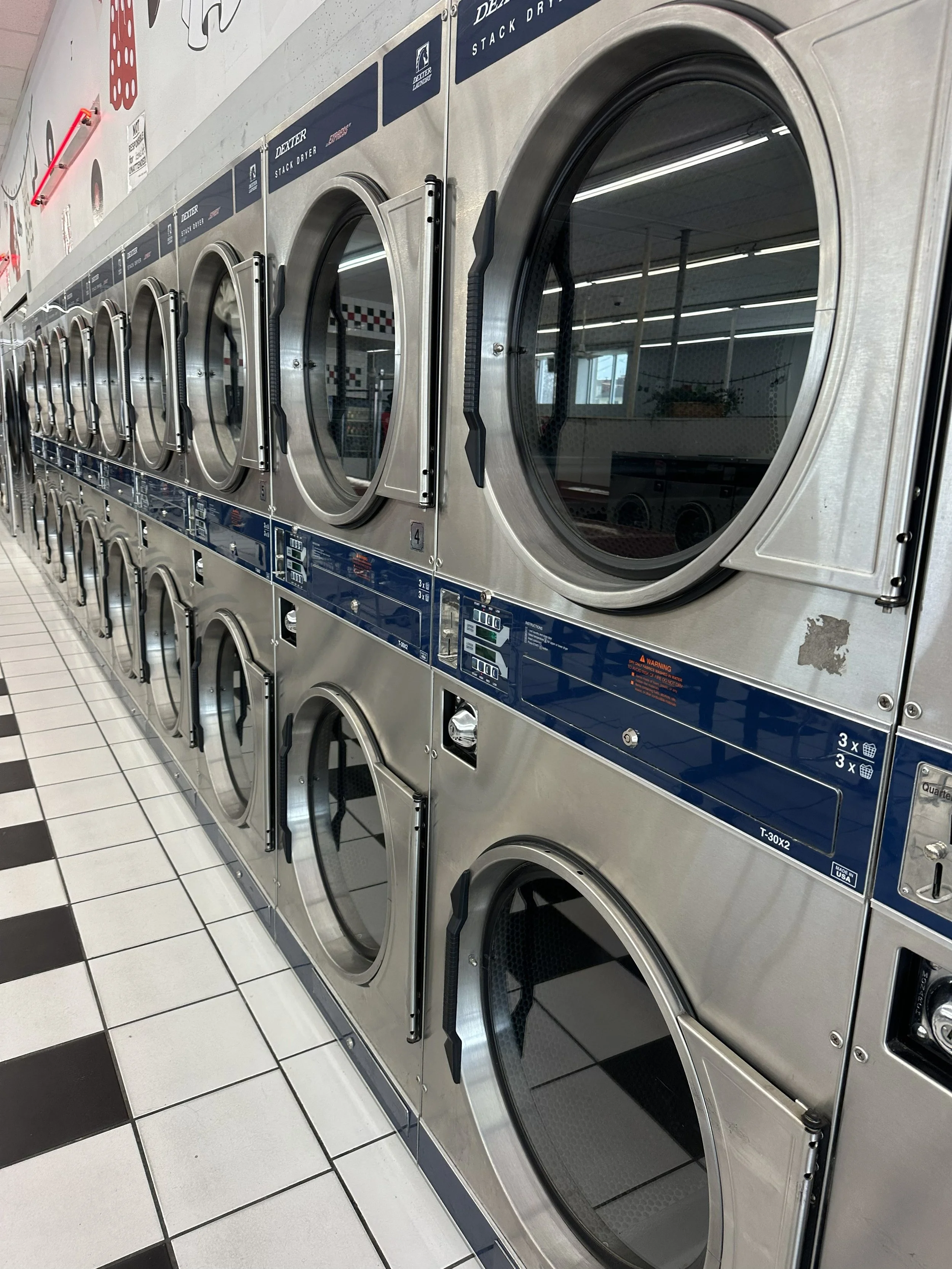 Rows of self-service laundry machines inside Main Street Laundry in Kansas City.