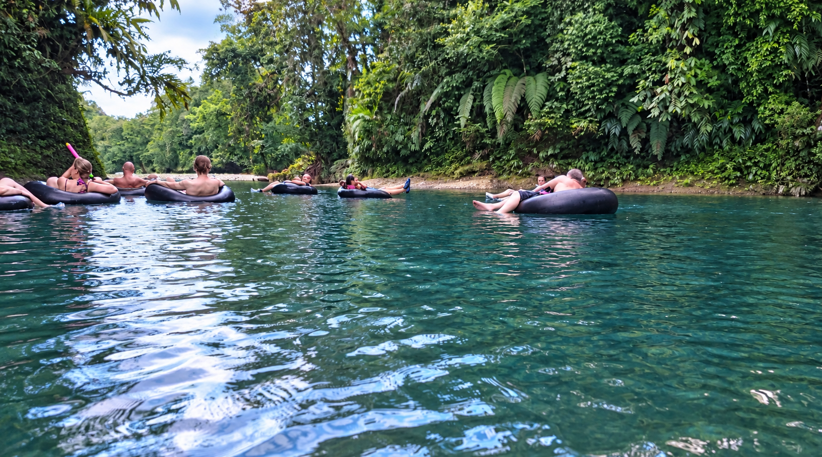 Visitors tubing on the rainforest river in San Cipriano, Colombia.