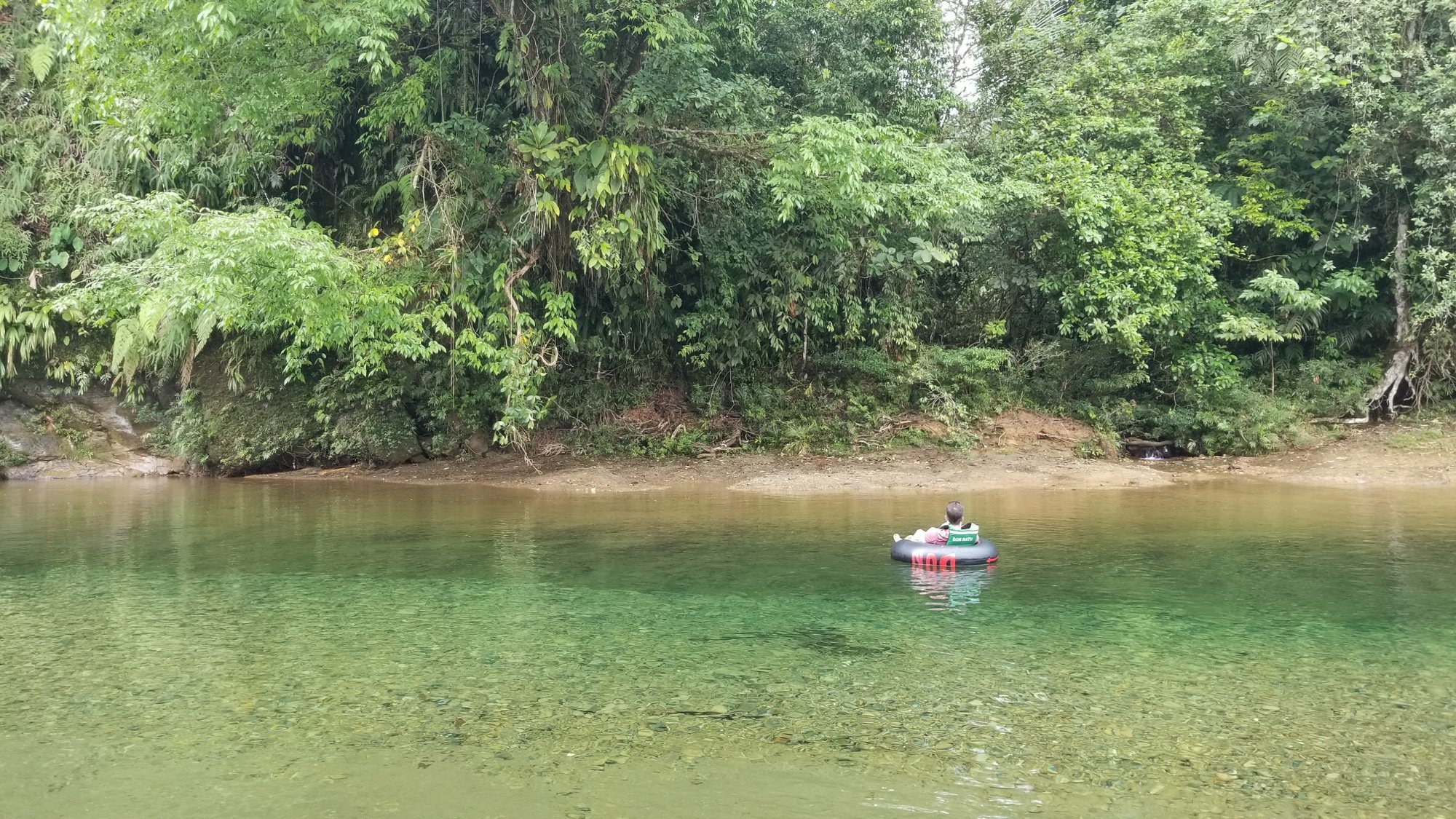 Tubing on the clear river at San Cipriano, surrounded by rainforest.