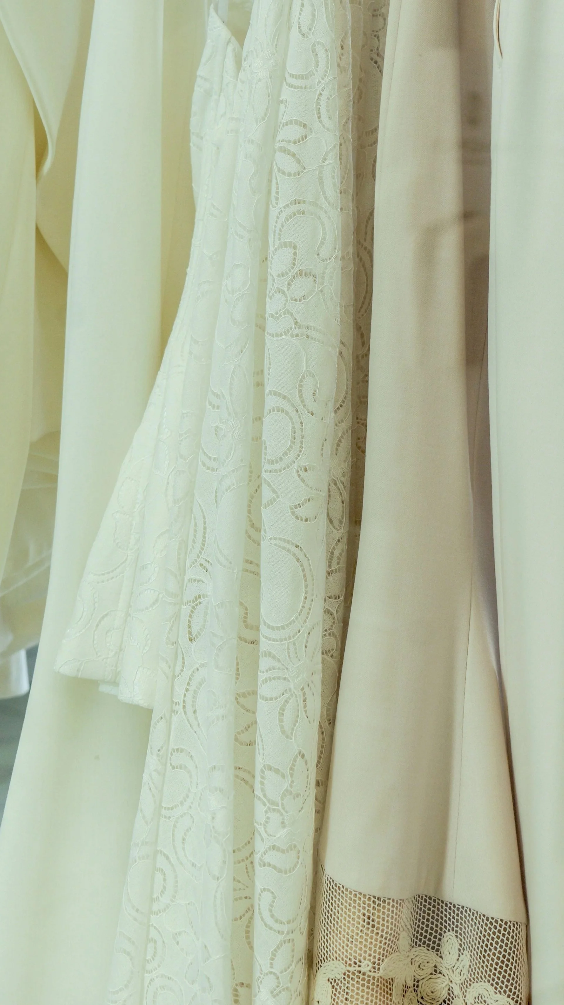White and cream lace garments hanging side by side